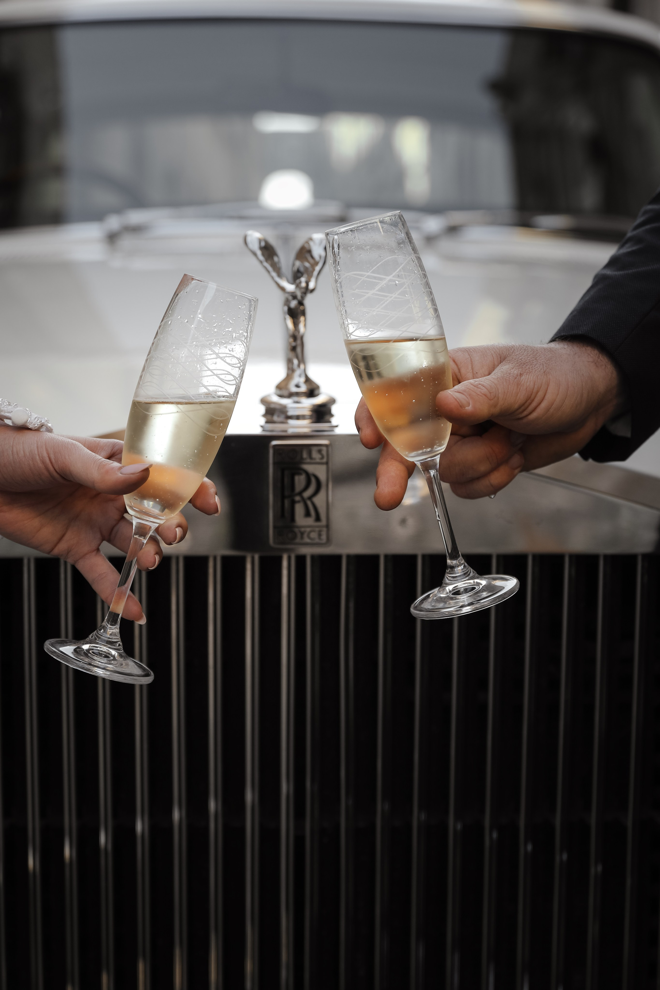 Two glasses of champaign next to Rolls Royce in old town of Rhodes island, Greece