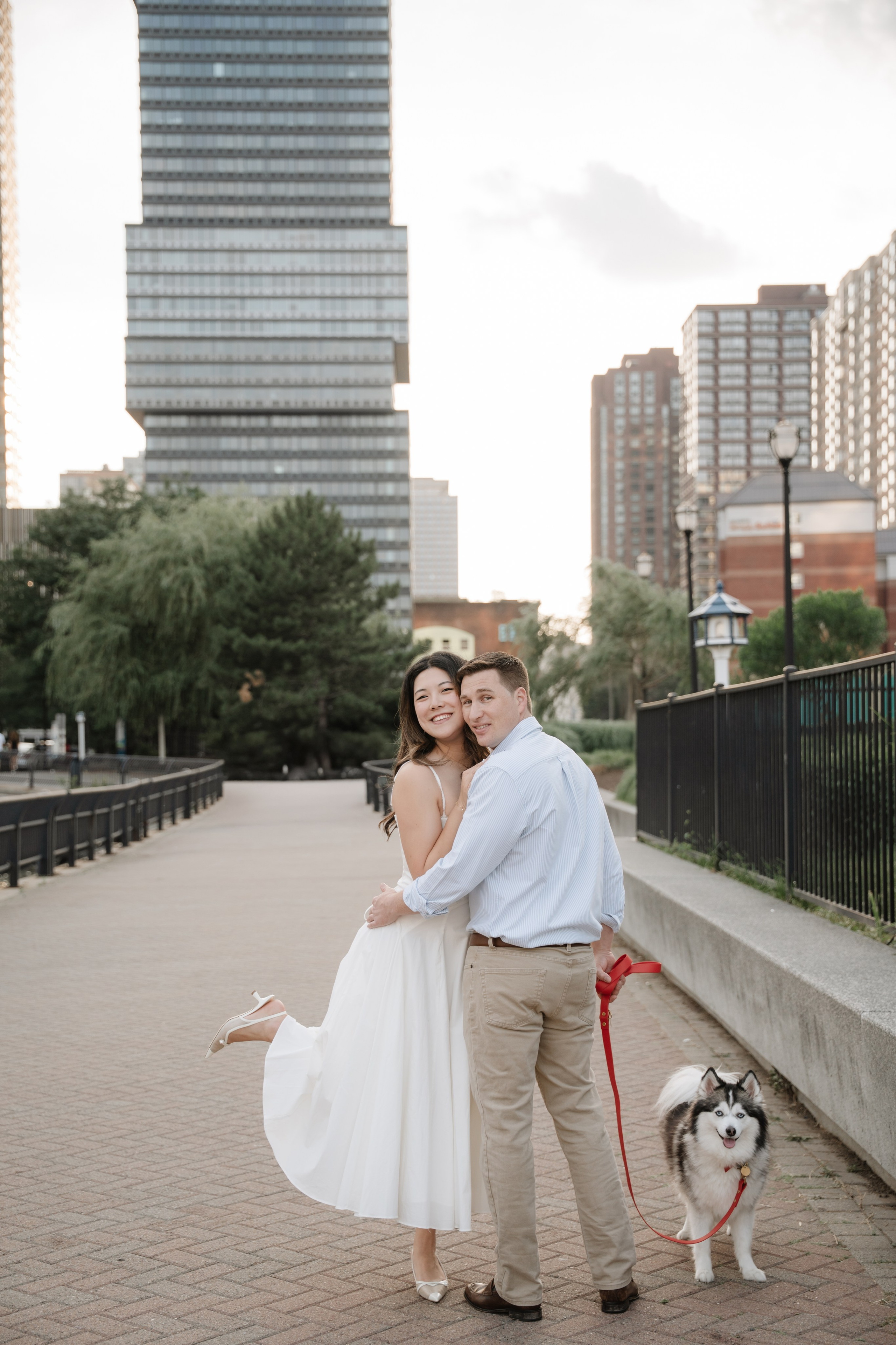 An adorable couple with their dog. Portrait and wedding photographer in New York