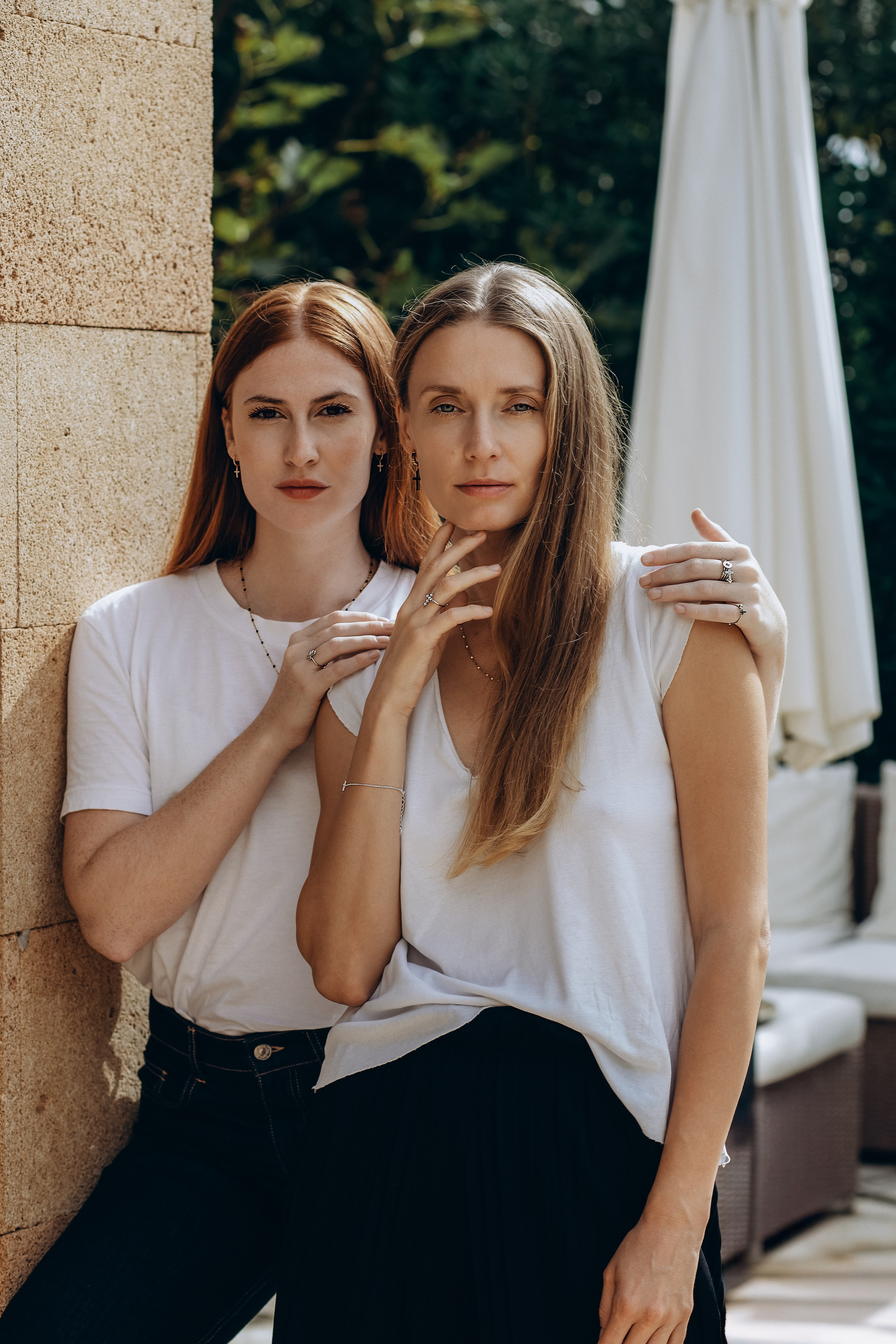 Natural light brand photoshoot in Valencia, Spain featuring two women showcasing minimalist jewelry and clean fashion styling. Ideal for content creators, jewelry brands, and businesses seeking professional brand or product photography in Valencia and across Spain.