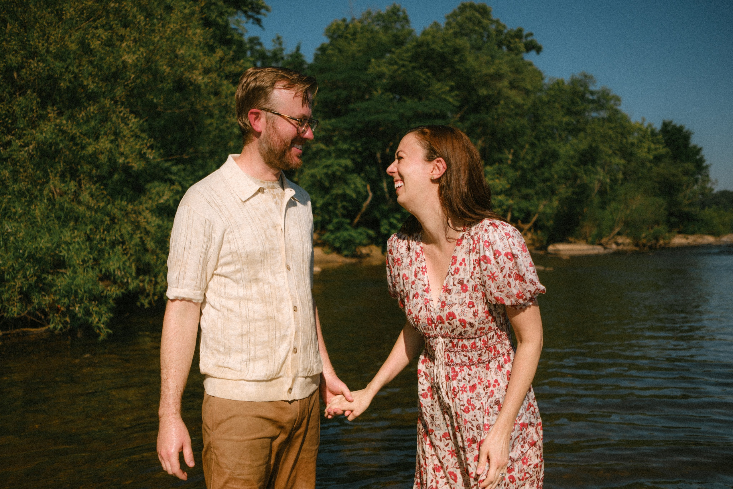 Documentary family photographer capturing candid, unposed moments of kids splashing in the James River water