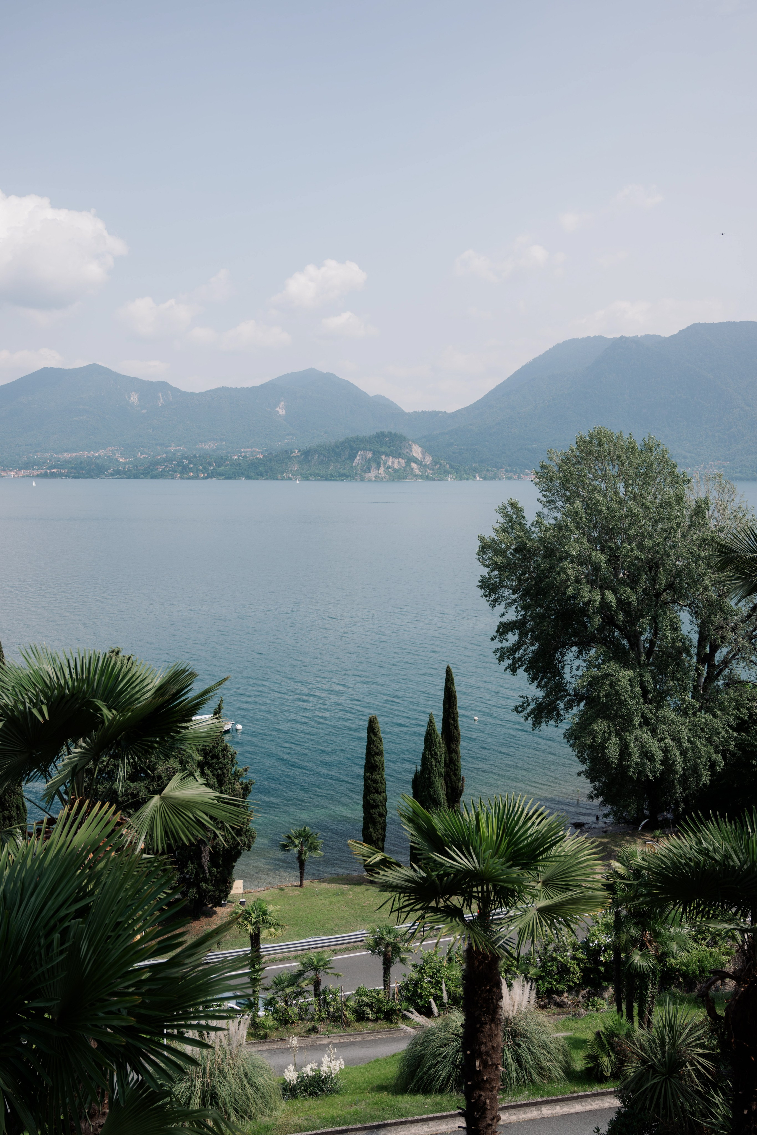 a view of a lake and mountains from a balcony