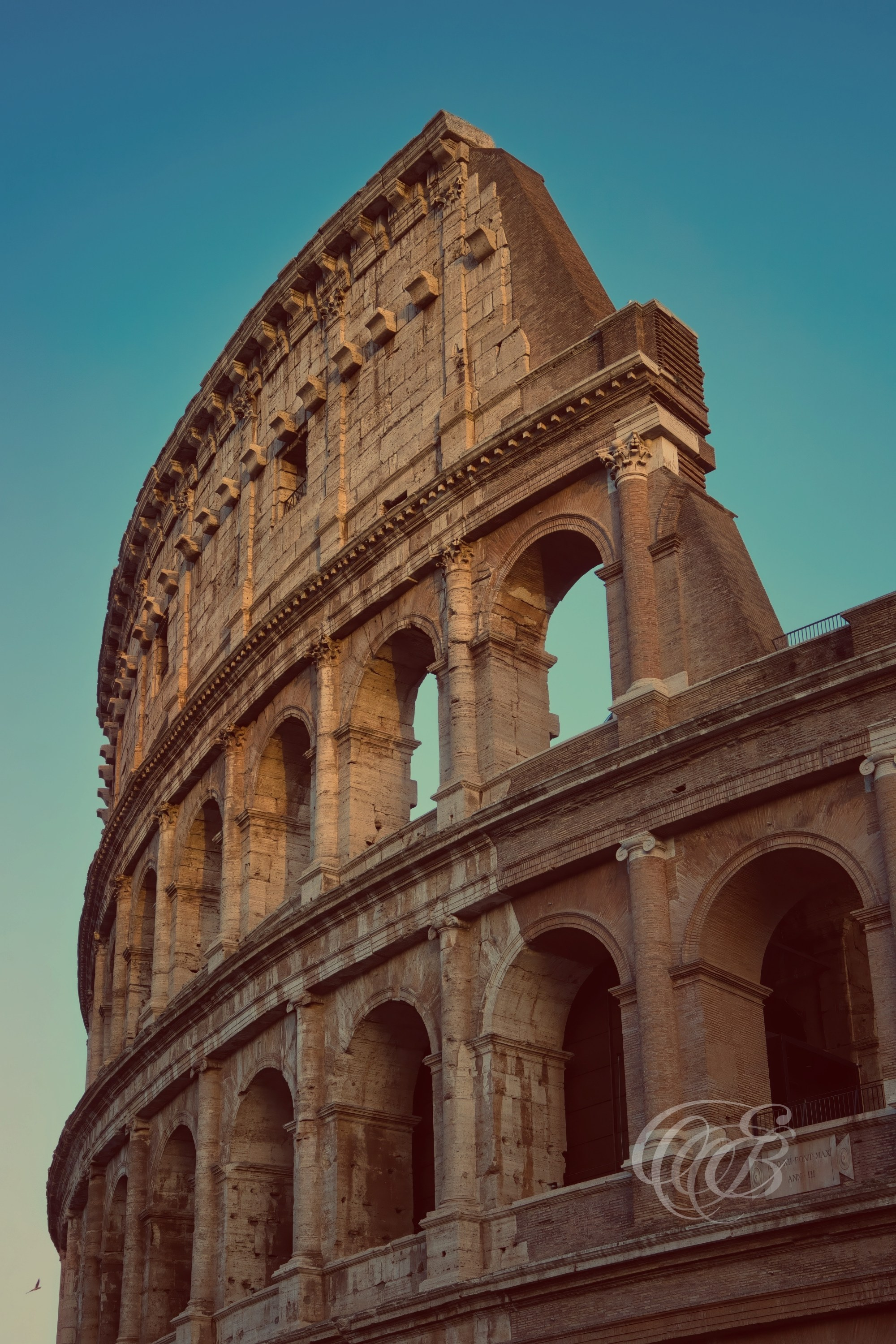 Rome, Italy – The Colosseum in the late afternoon – Eduardo Bartoli Fine Art Photography – Late afternoon view of the Colosseum’s eastern façade with sunlight highlighting its travertine arches and exposed vaults in Rome, Italy.