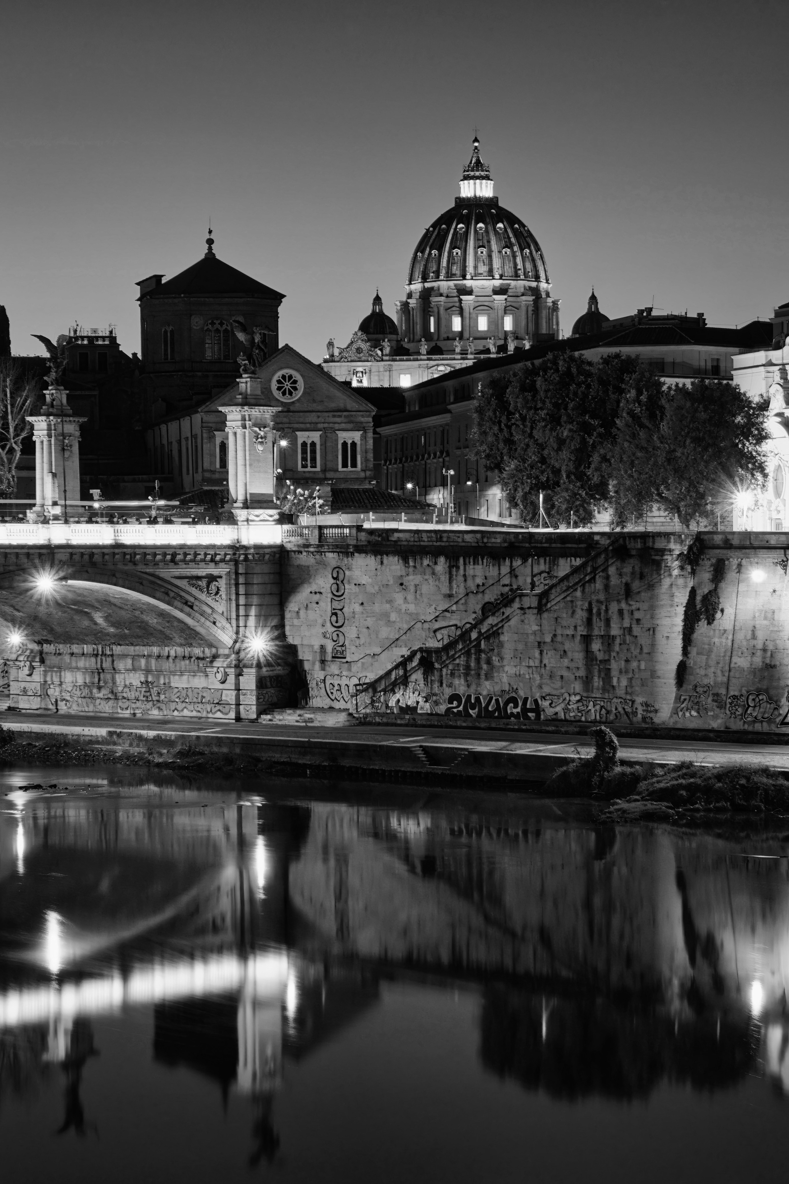 Rome, Italy – Ponte Vittorio Emanuele II over the Tiber River at sunset, early 20th-century monumental bridge architecture photographed in black and white fine art photography. Rome, Italy – fine art photography by Eduardo Bartoli.