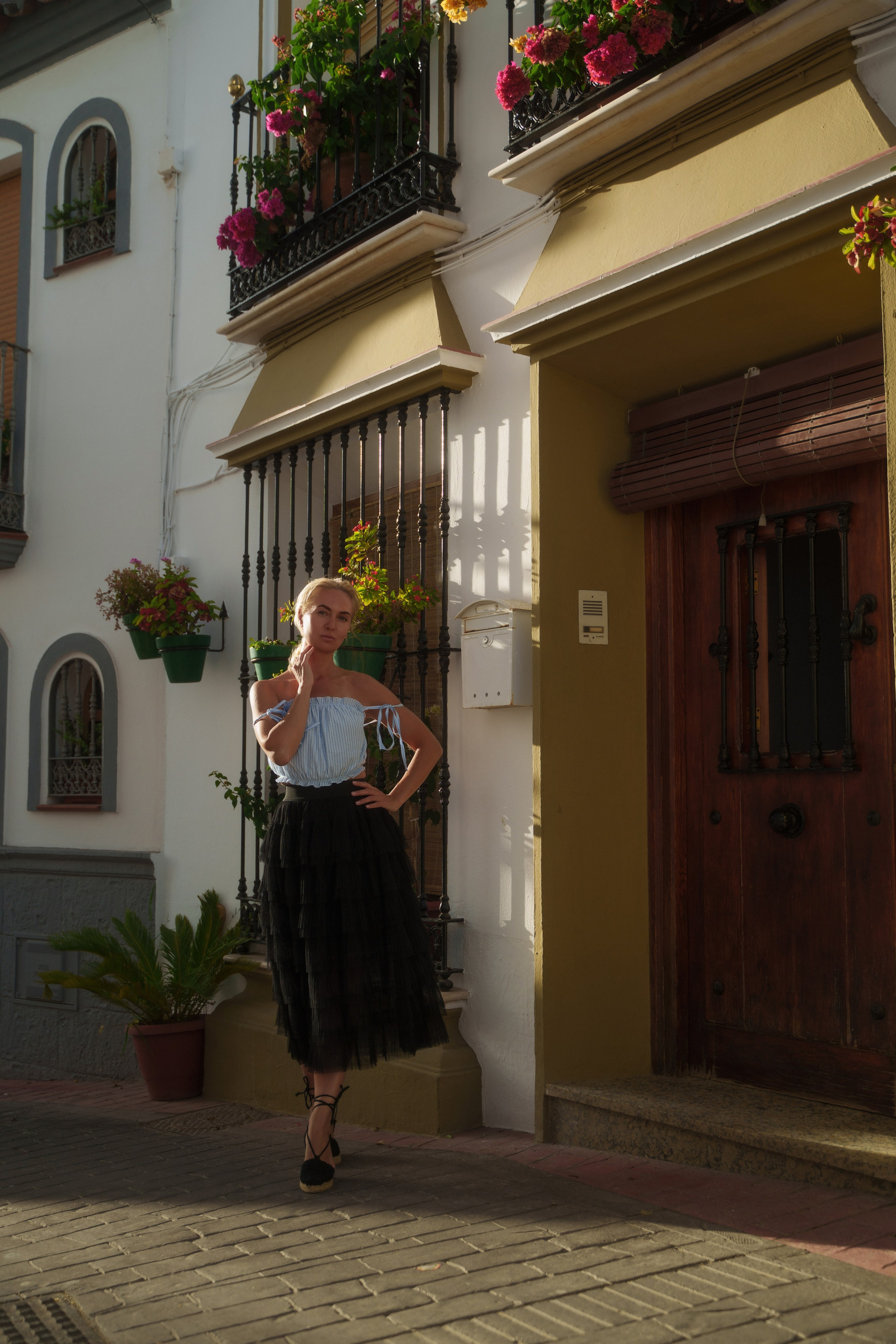 Portrait of a beautiful blonde model in the colorful streets of Estepona, captured by a female photographer