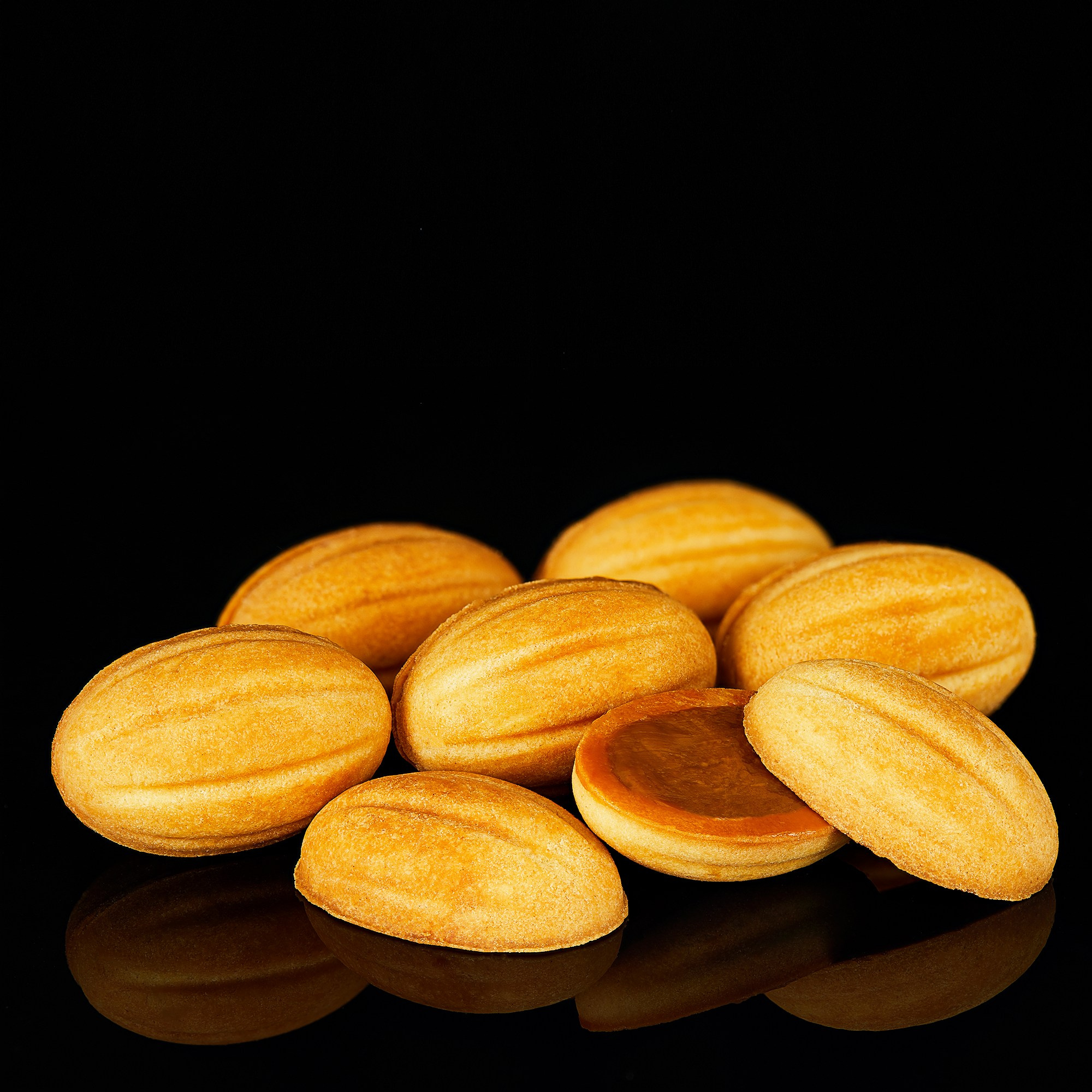 Photographer Roman Djuzev - Cookies "Nuts" with boiled condensed milk and walnuts plan on a dark background.