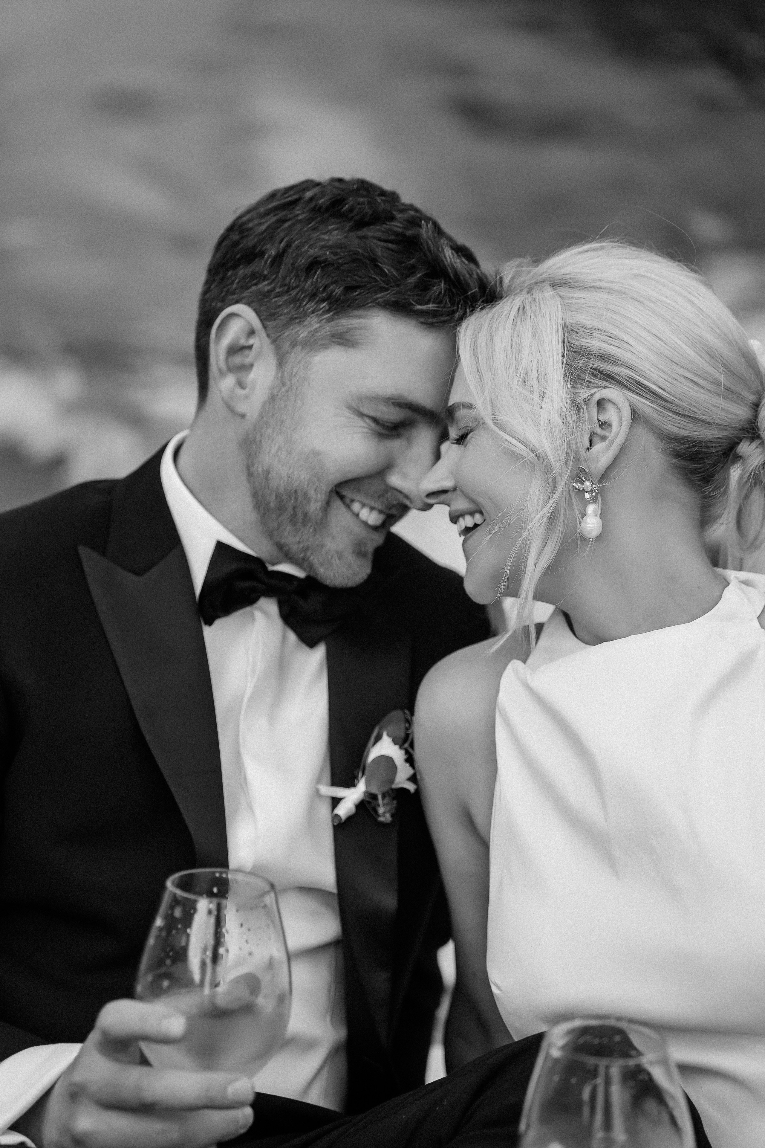 Black and white close-up of the bride and groom on the boat at Villa Lario, Lake Como, Italy