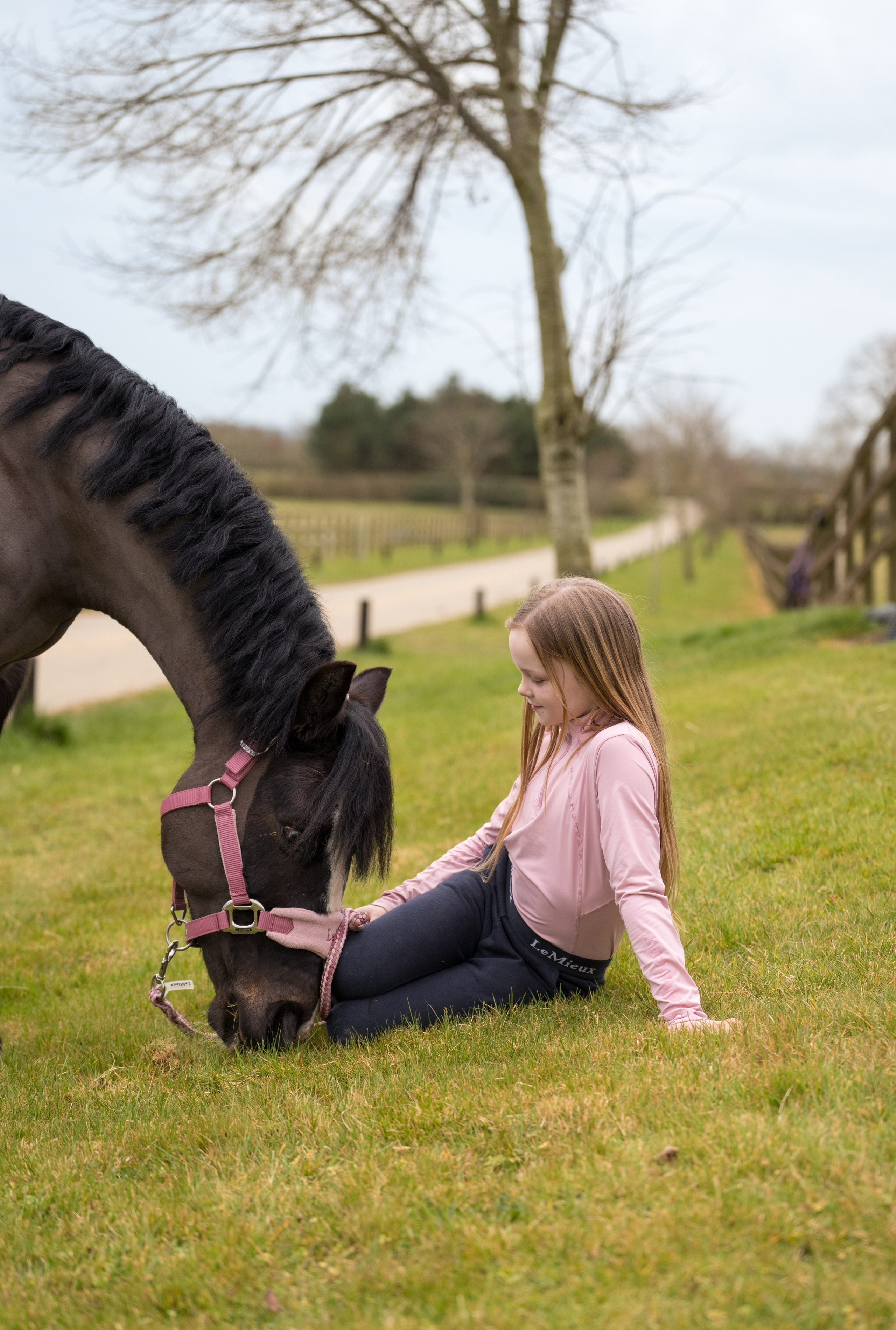 Child in traditional riding outfit with pony during equestrian show in Leicestershire
