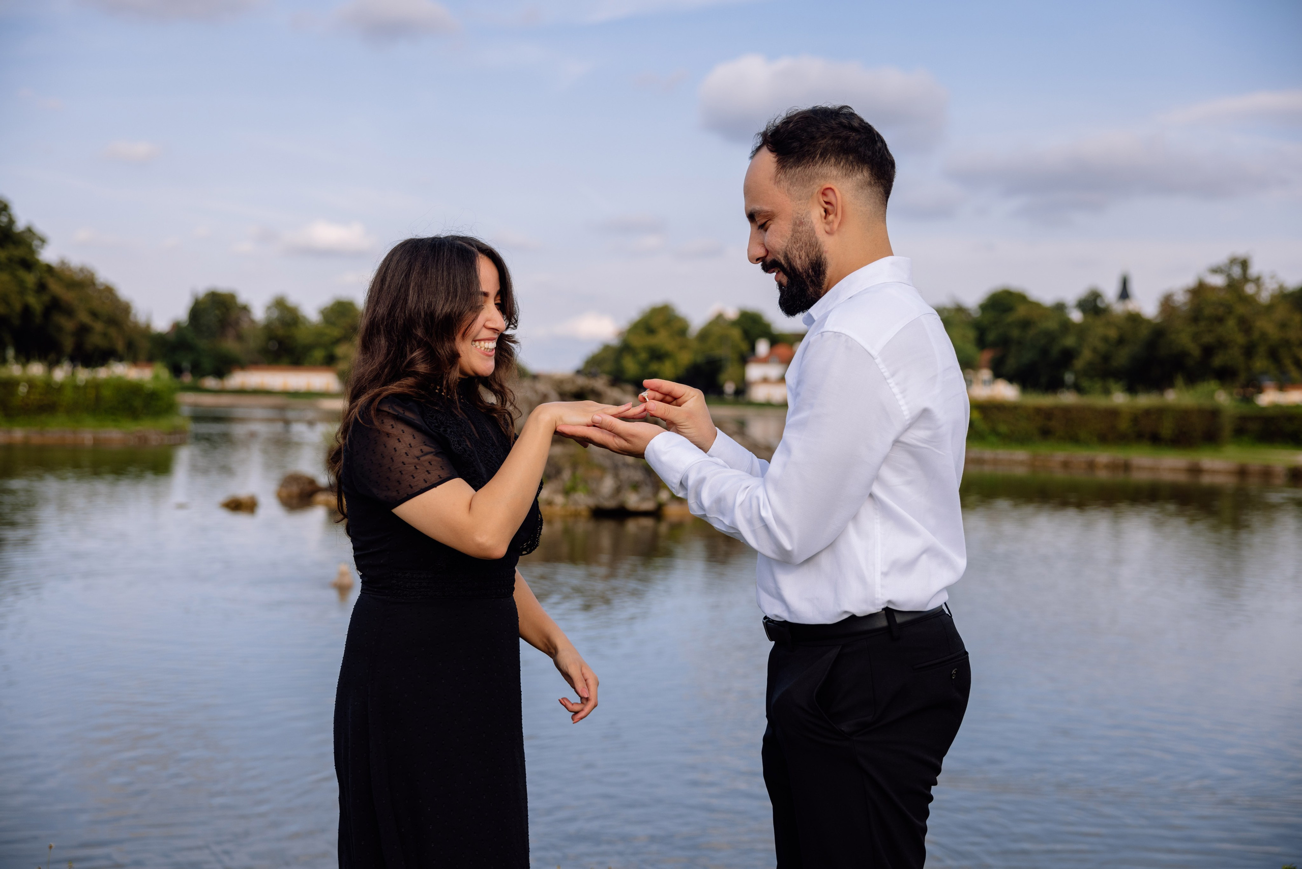 Bräutigam steckt der Braut den Ring an vor dem Schloss Nymphenburg
