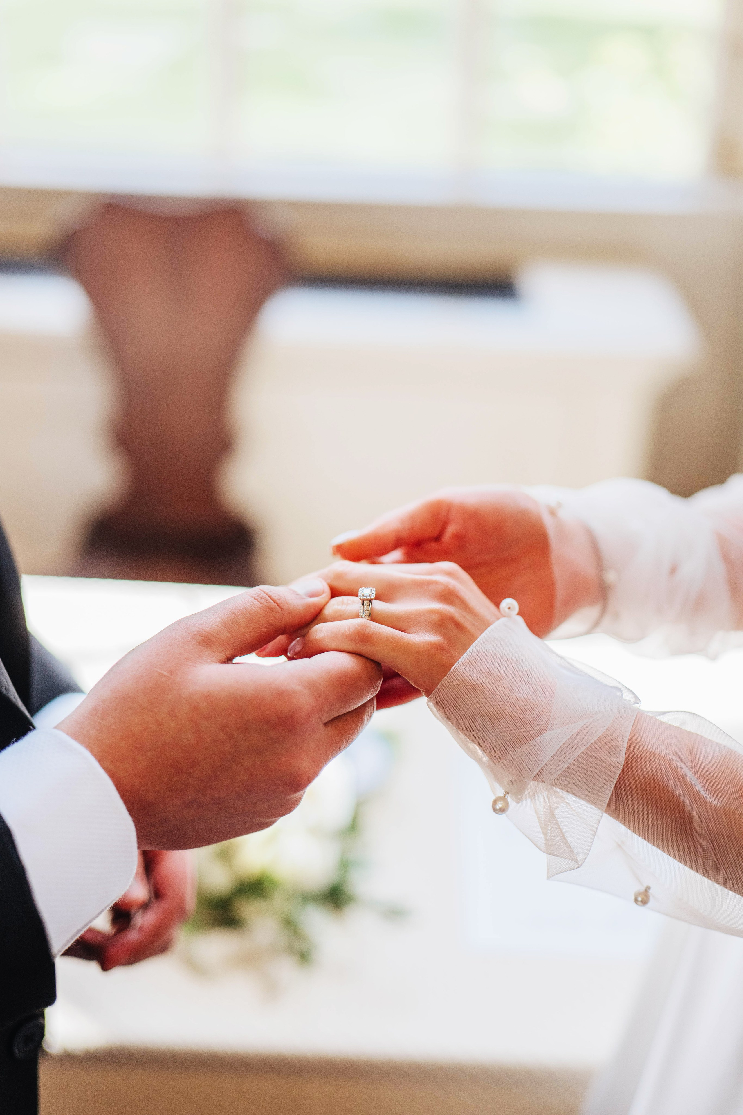 photo of the wedding ceremony, close up of bride and groom holding hands