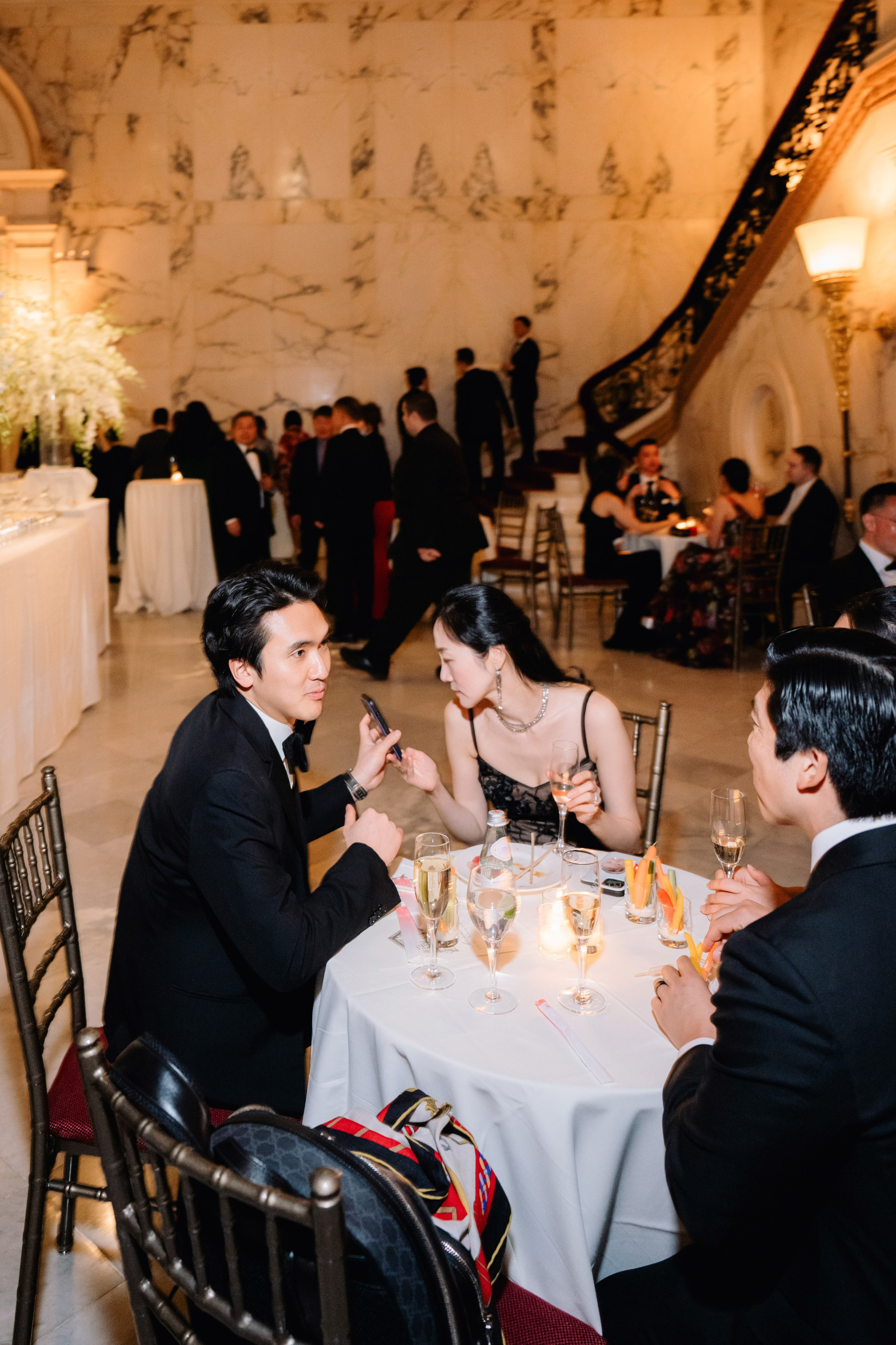 a couple sitting at a table with wine glasses