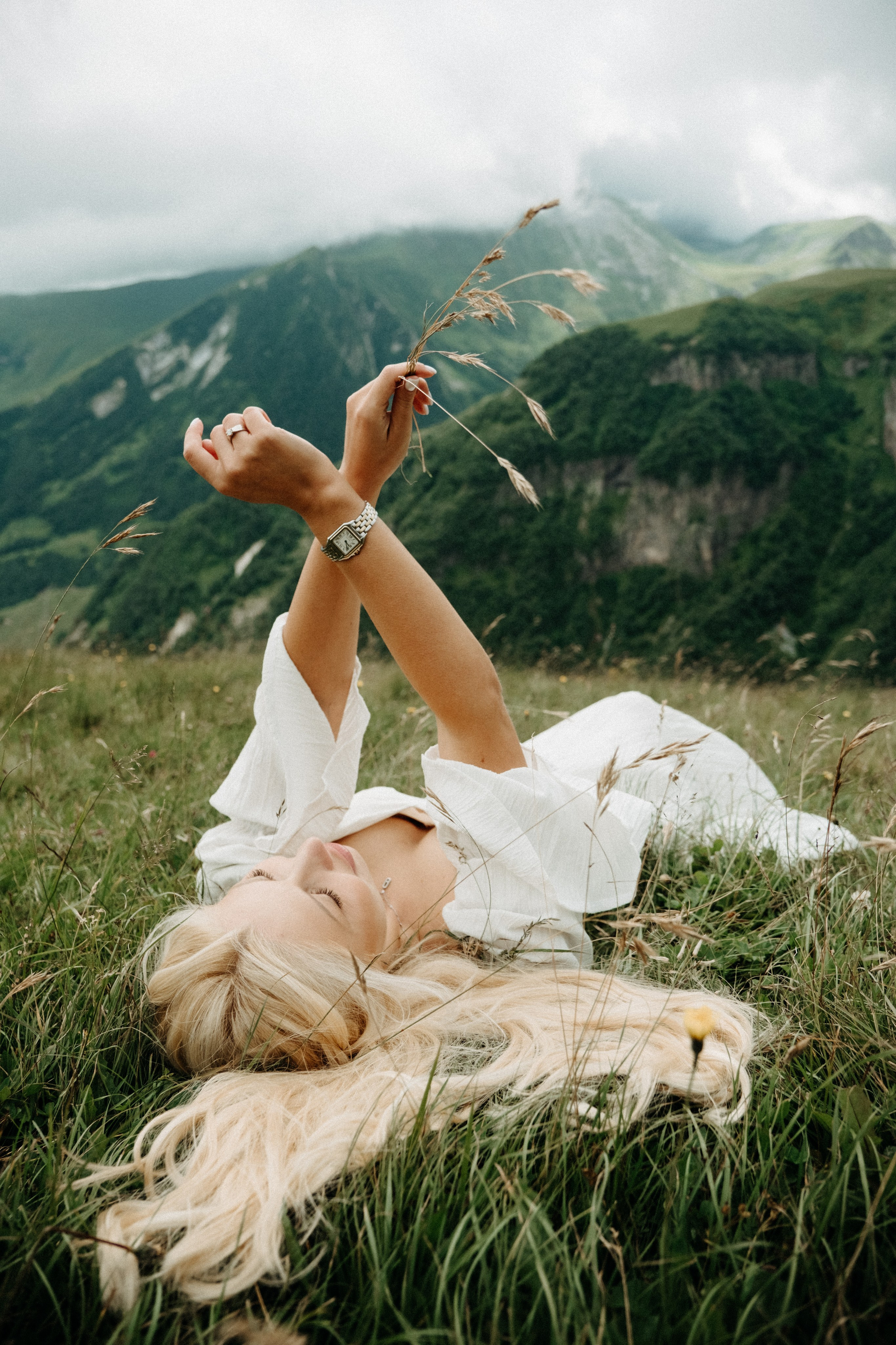 Woman holding flowers in mountain landscape