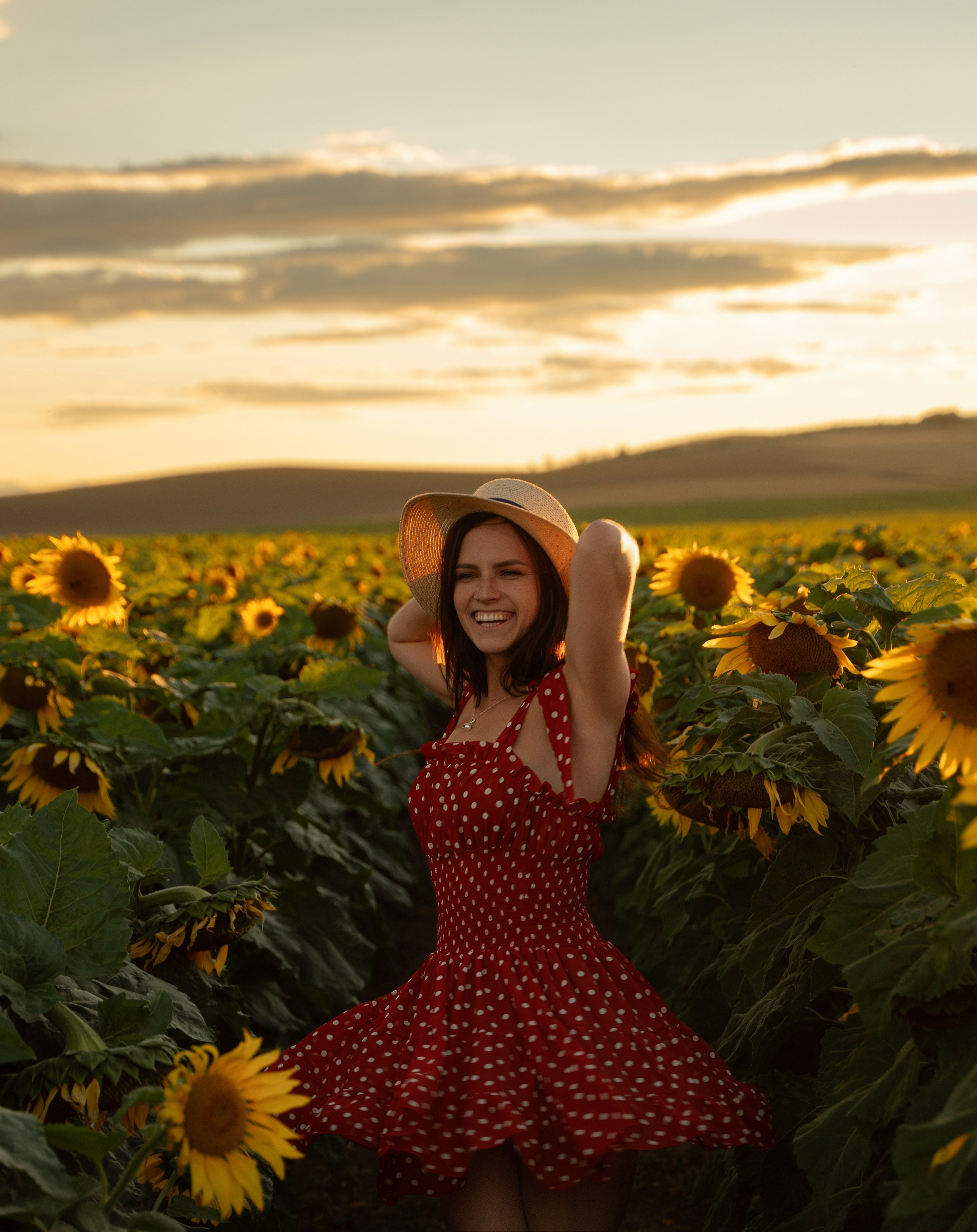 Sunset portrait of beautiful female model in sunflower field, Marbella photography