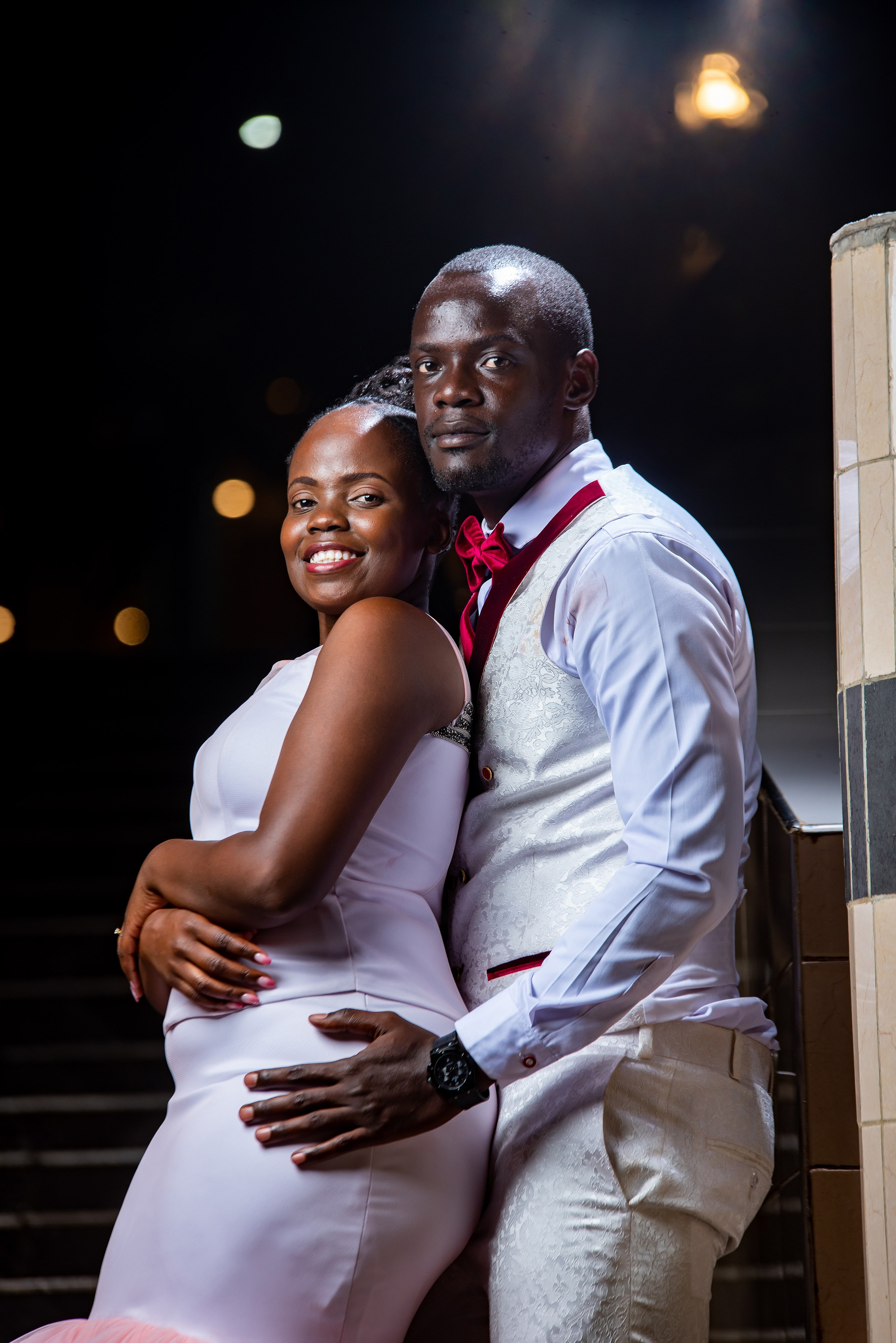 An intimate medium-portrait of a bride & groom during a nigh photo session on their wedding day. Wedding photography