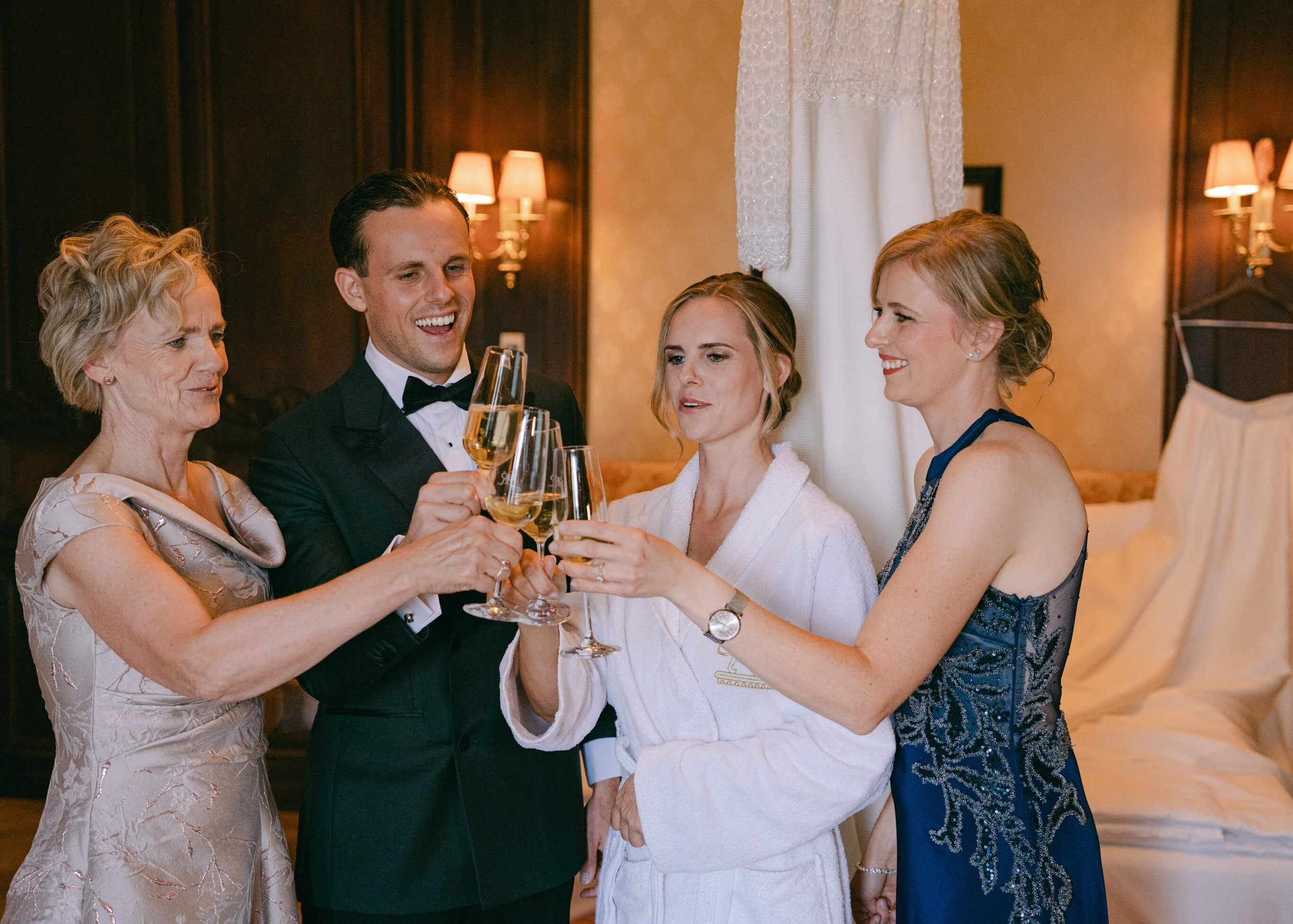 Groom and wedding guests toasting with champagne, getting ready at Villa Rothschild Frankfurt luxury wedding