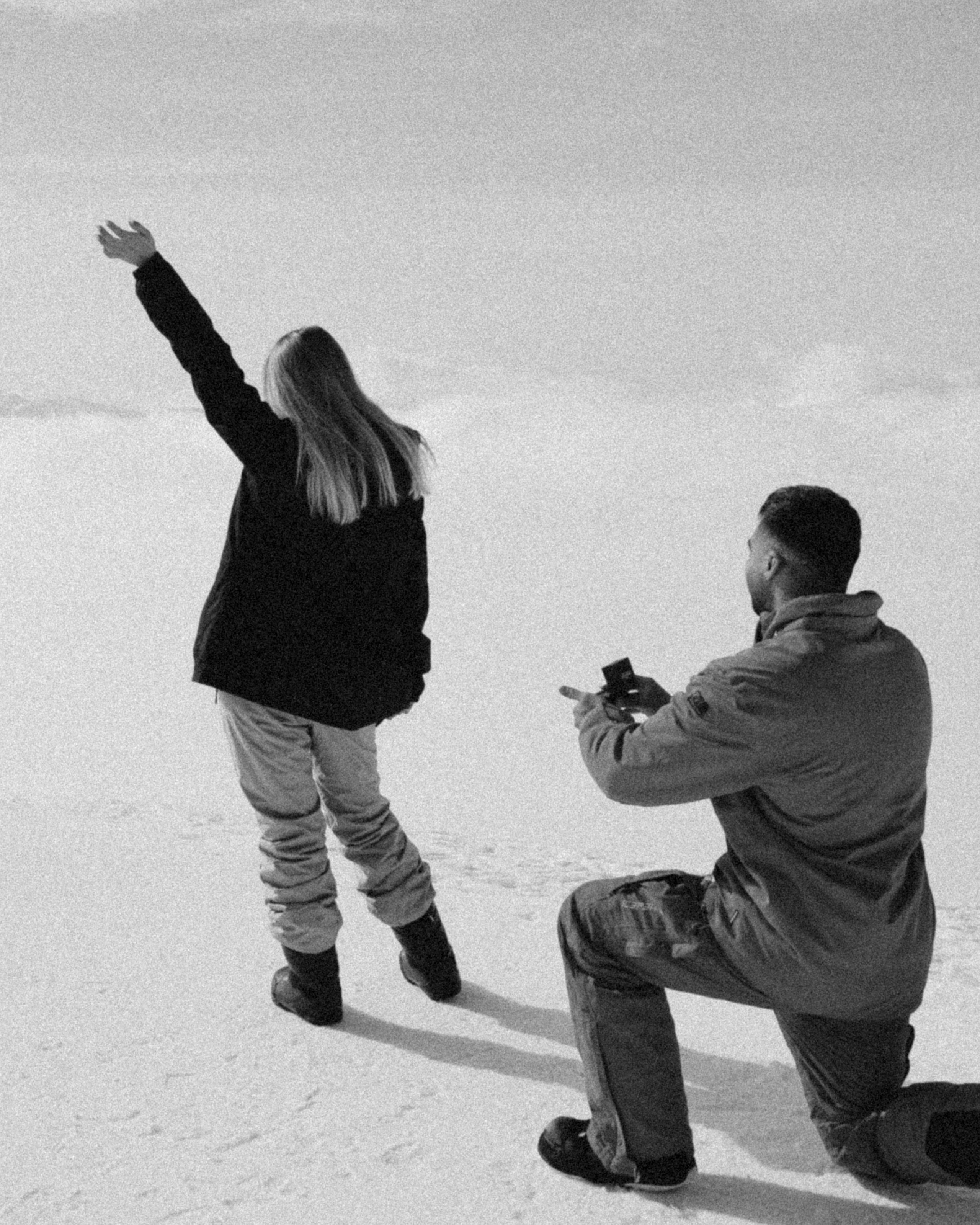 Winter proposal at Gudauri Ski Resort with snowboarders couple 