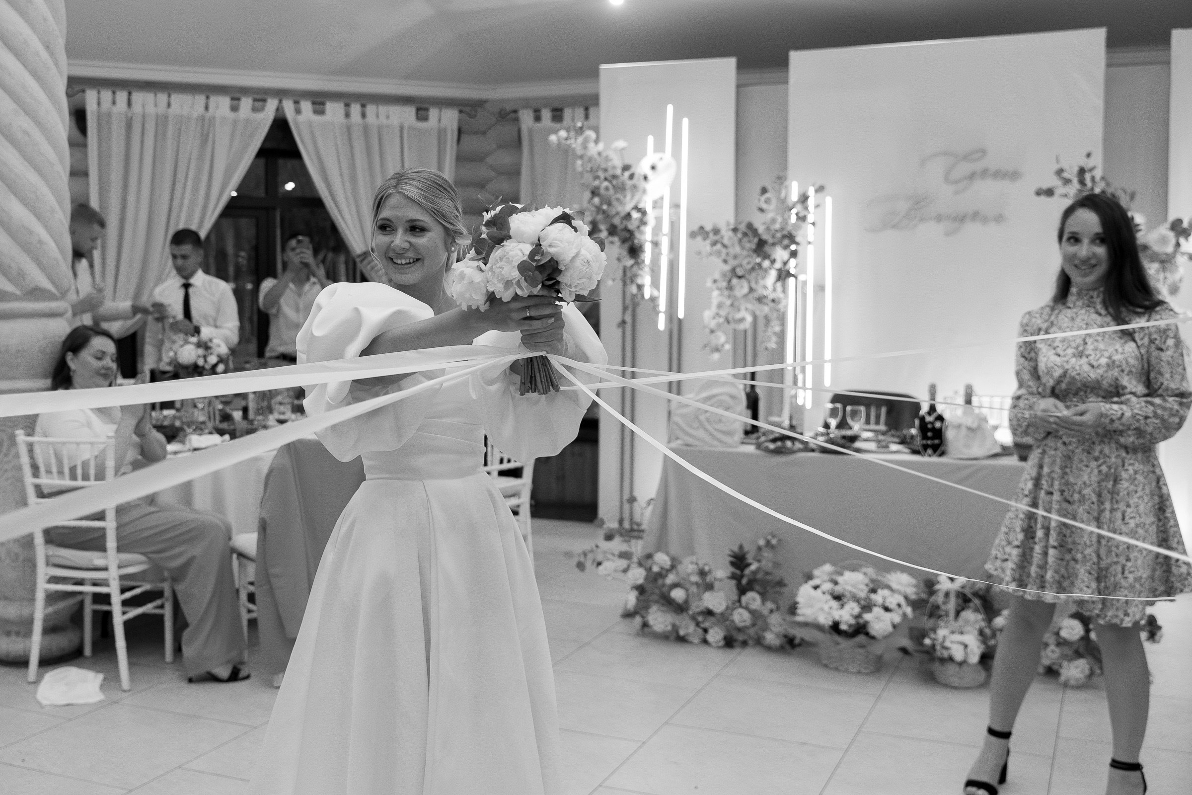 Bride bouquet toss, by Bude, Cornwall wedding photographer.