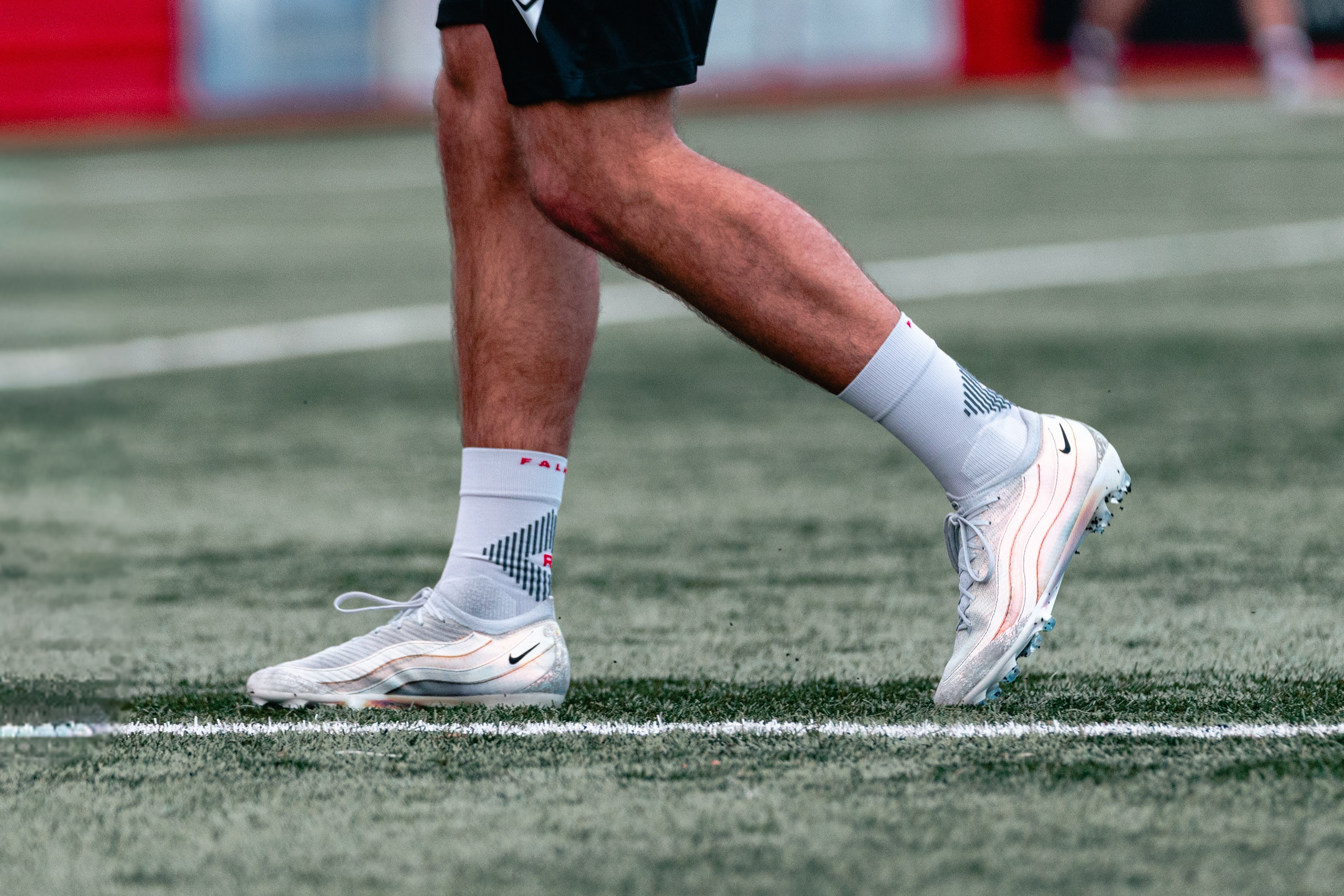 Close-up of a player’s white football boots and socks on the pitch before Tamworth FC vs Hartlepool United.