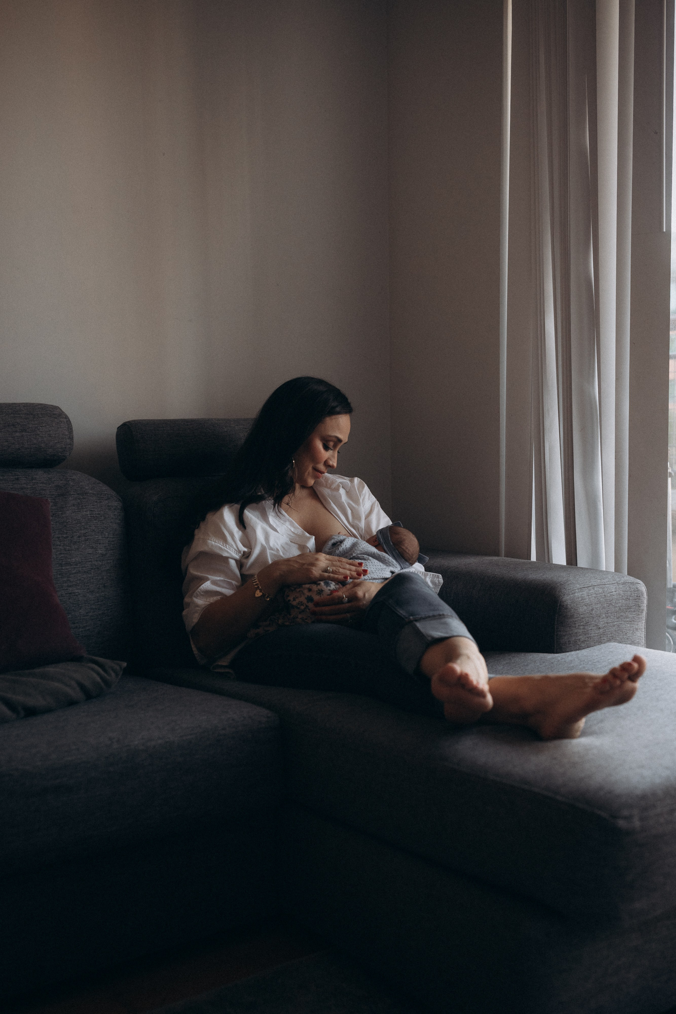 woman feeding newborn baby