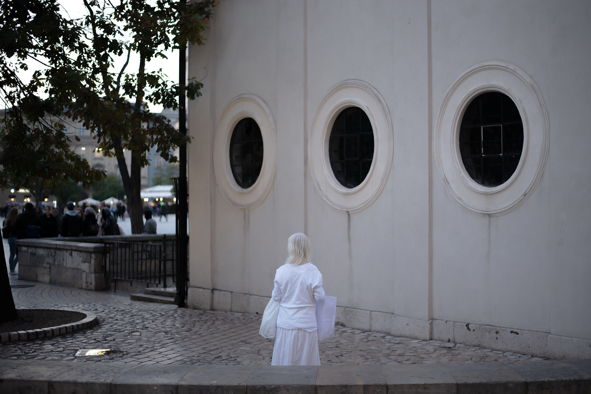 Lonely woman in white clothes in the city center Loneliness