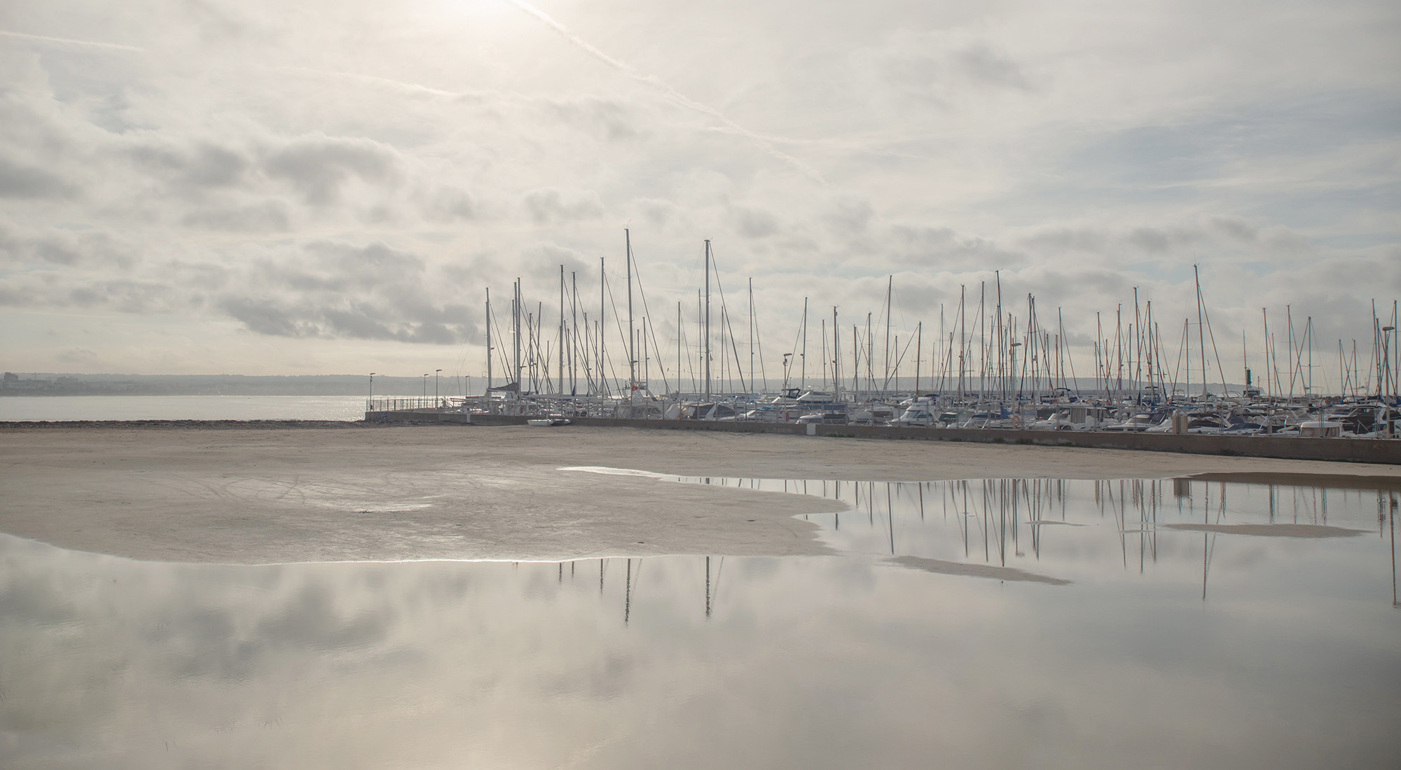 Seascape with reflection in water of yachts