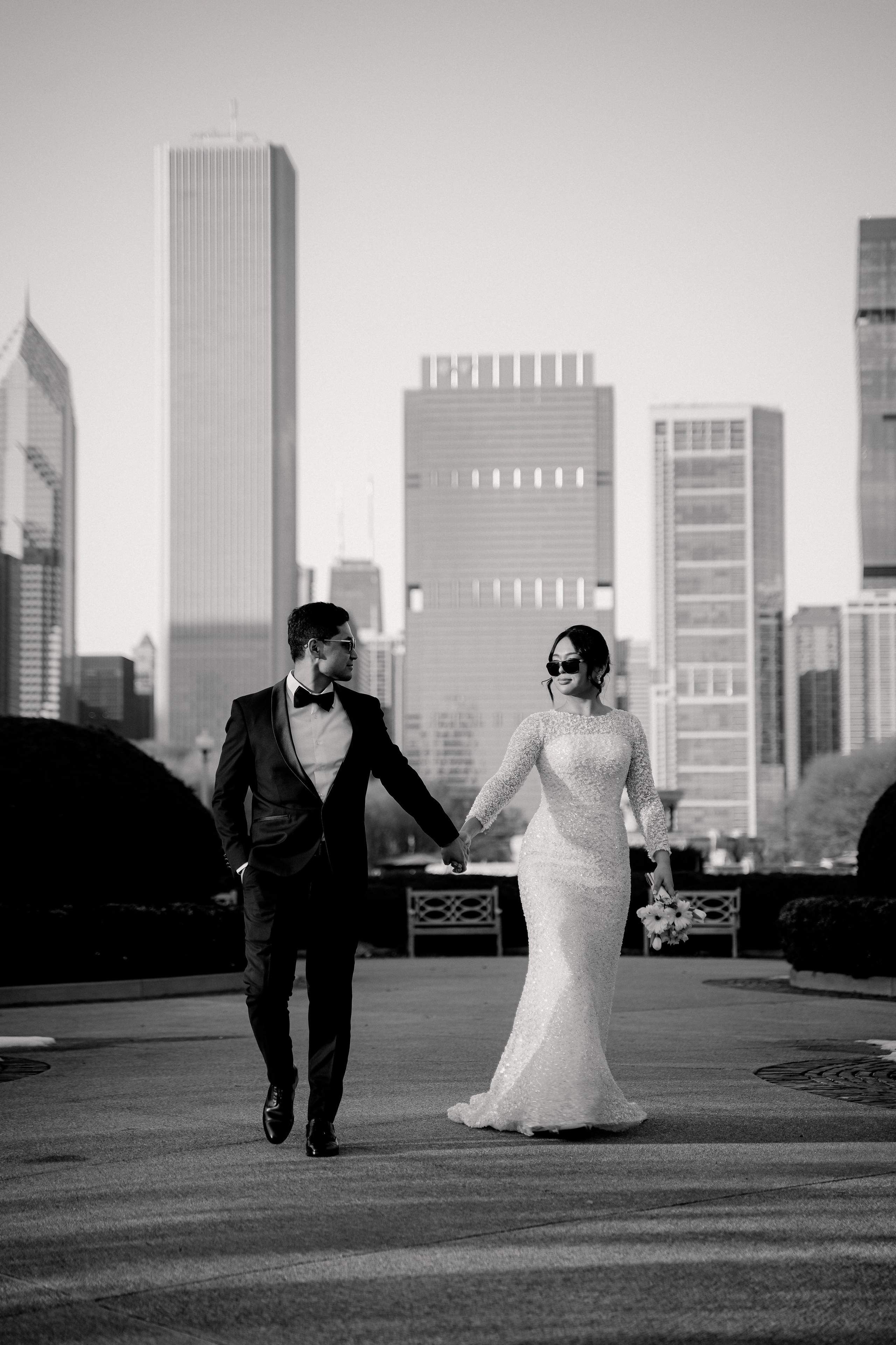 Bride and groom wedding portrait at Millennium Park Chicago with downtown skyline view and romantic city atmosphere.