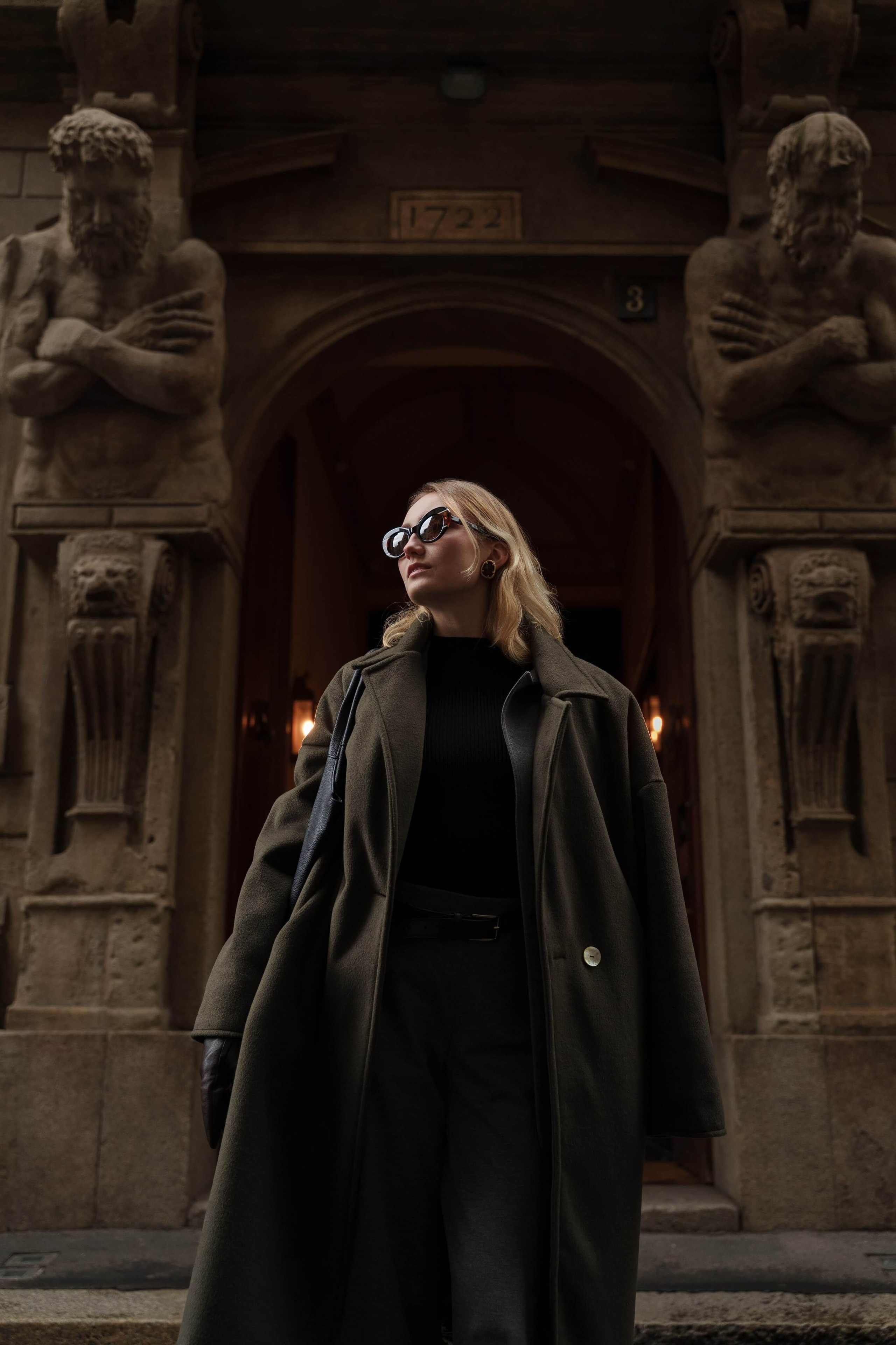 Eyewear campaign photography – woman in sunglasses walking past historic Milan architecture