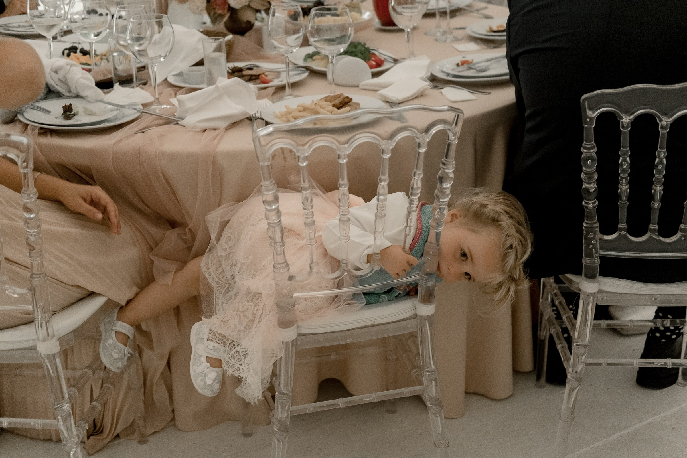 Tired kid at reception, by Bude, Cornwall reportage photographer.