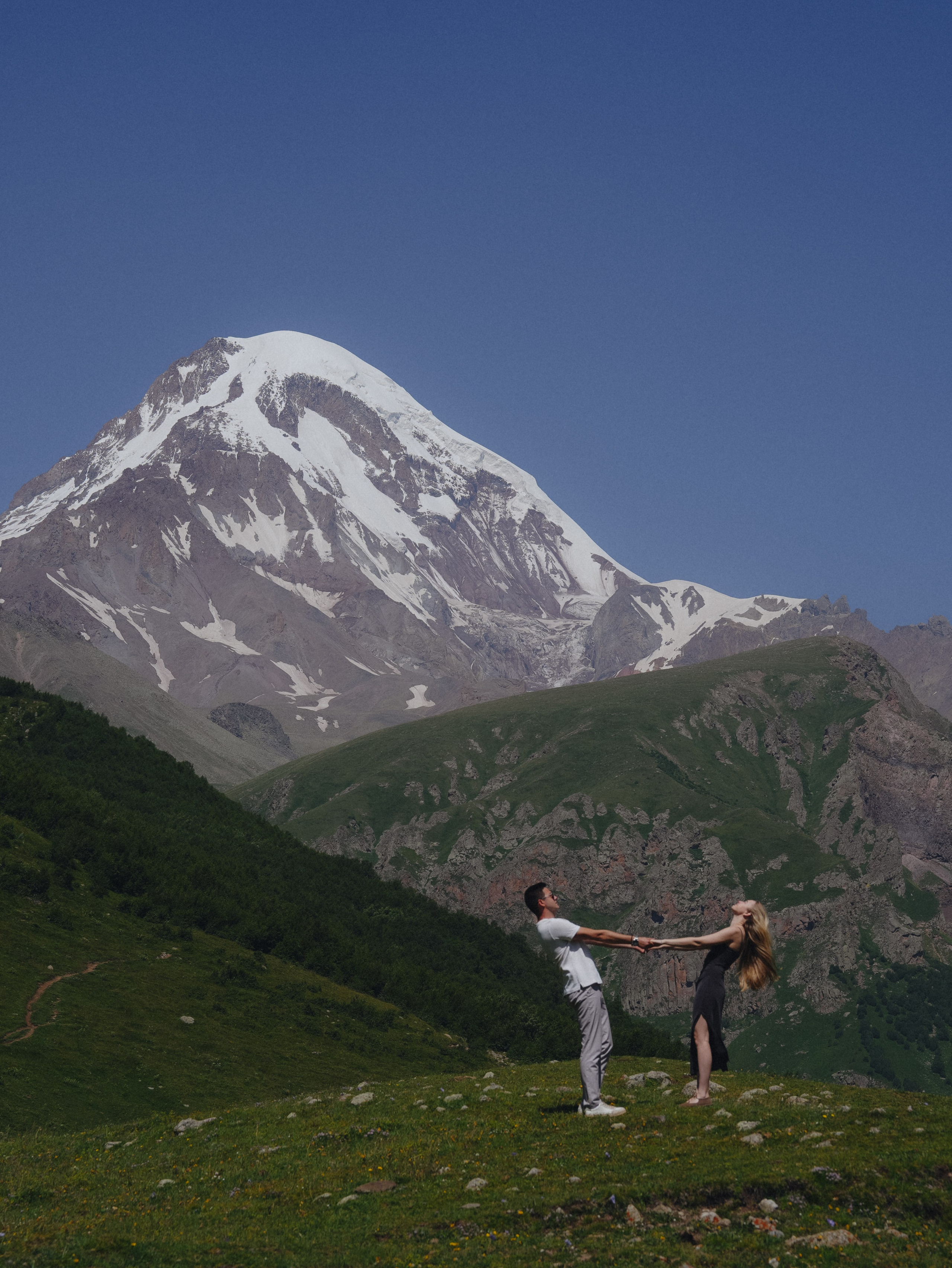 Couple dancing under Mount Kazbek landscape