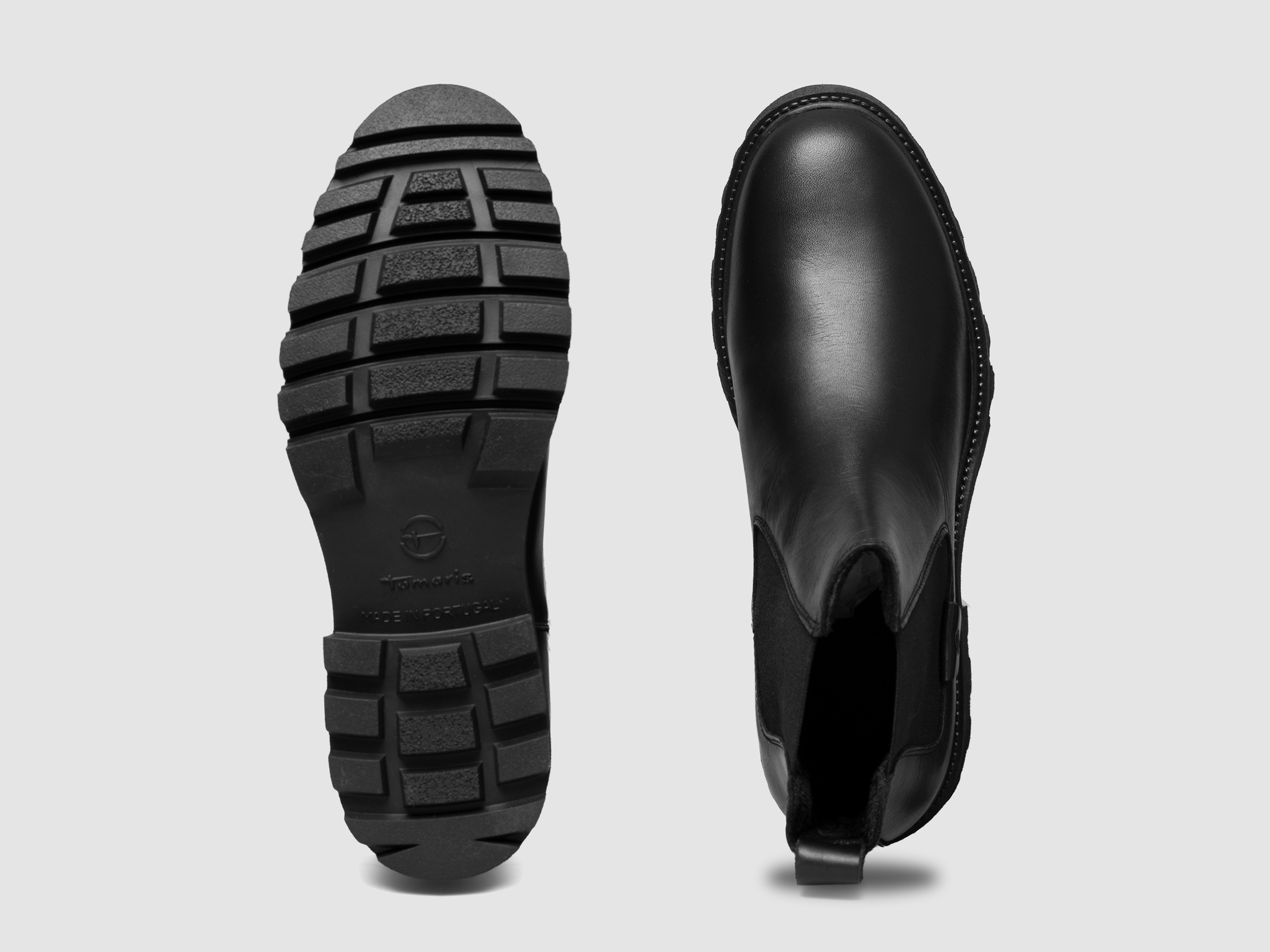 Black boots sole bottom view tread pattern product photography
