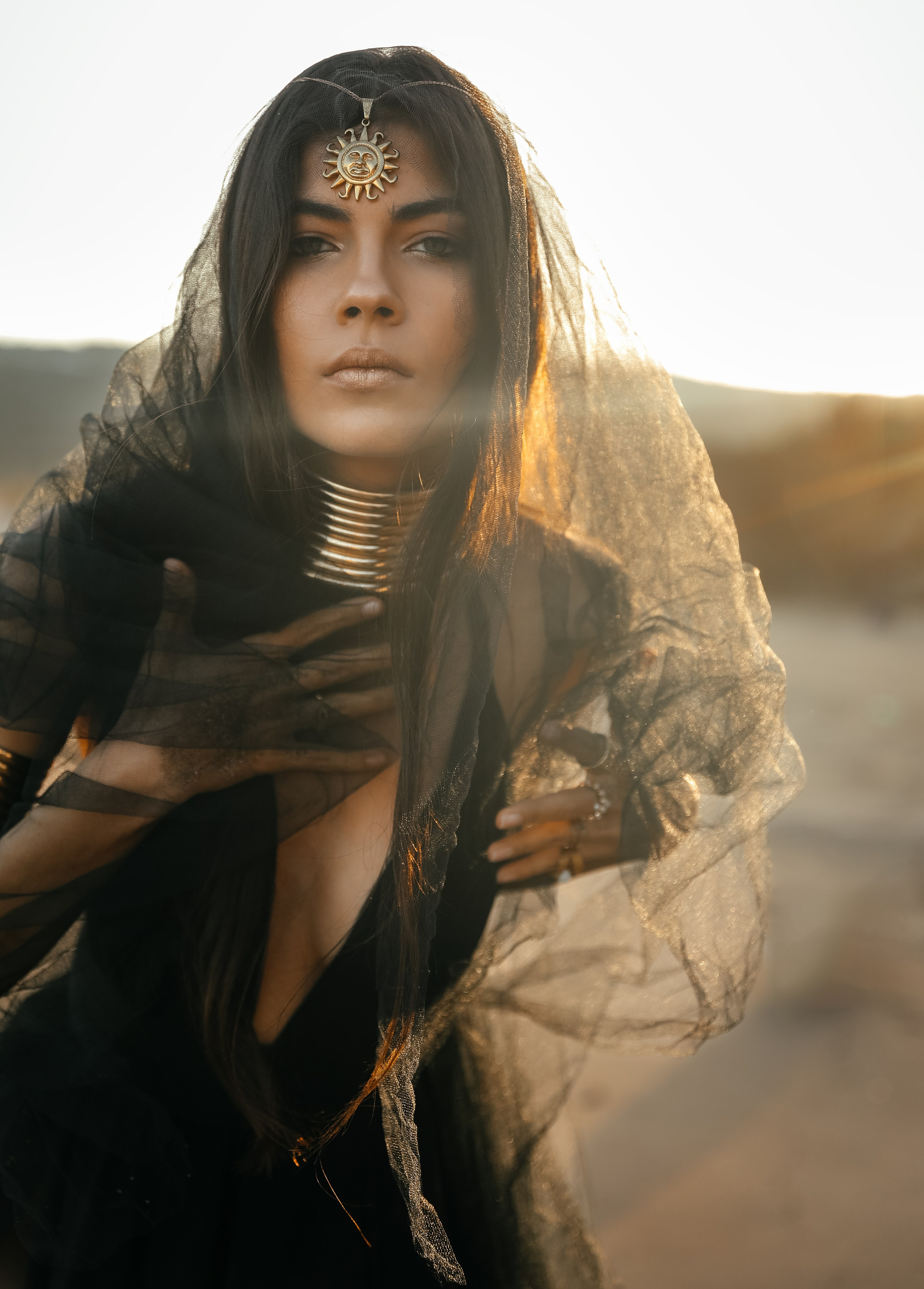 A chic girl in a black dress in the Desert against the setting sun. Rhodes island, Greece