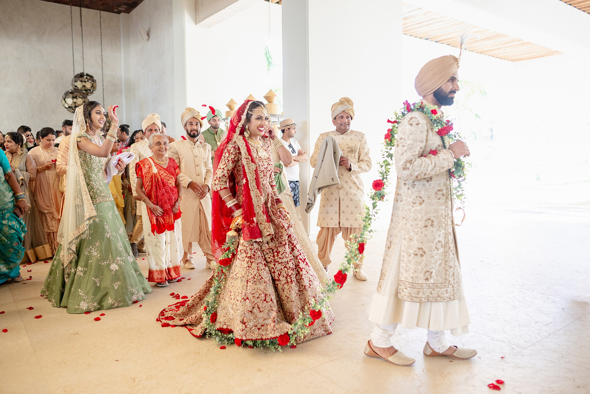 Indian wedding couple walking through Paradisus Hilton Los Cabos lobby after ceremony destination wedding