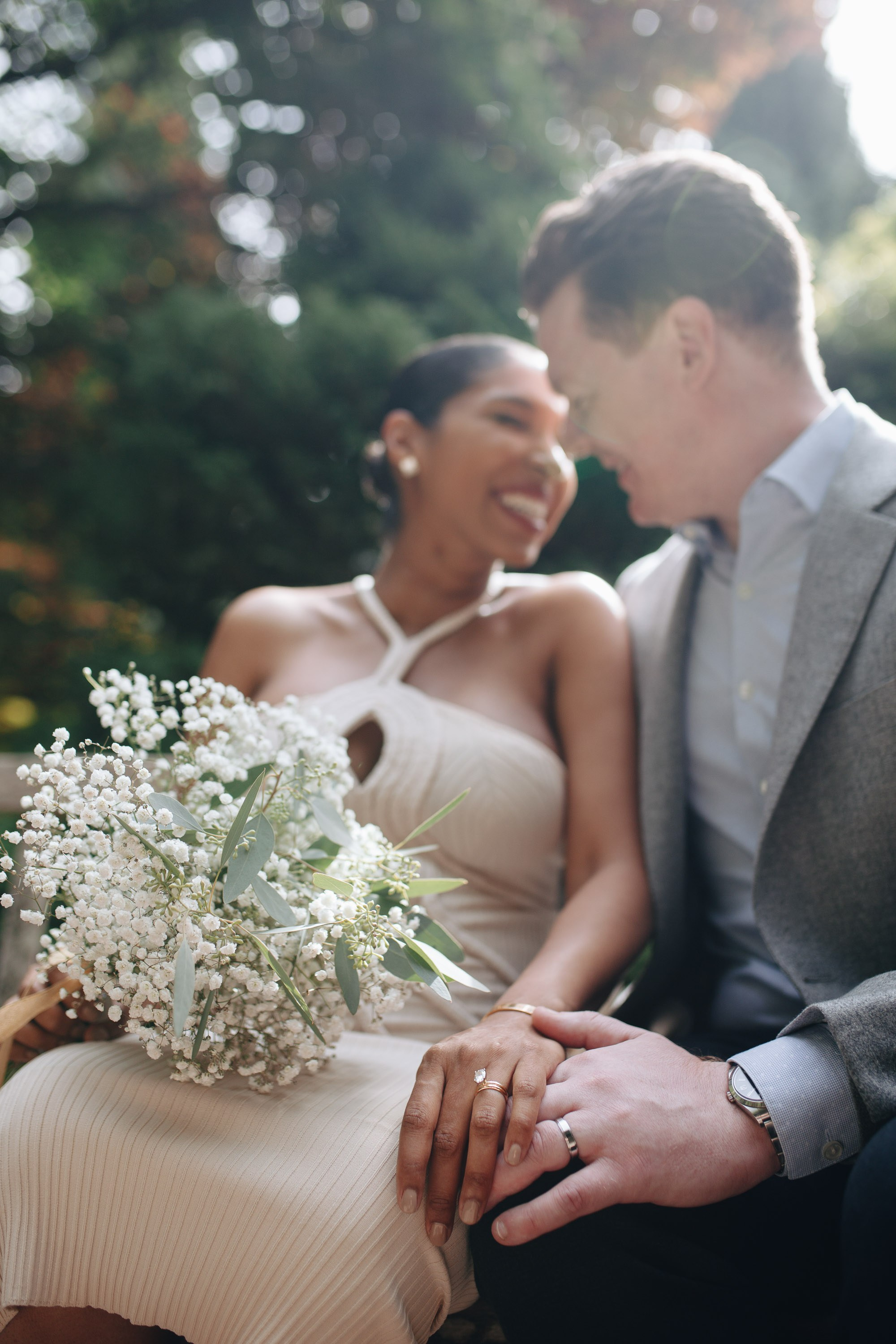 Bride and groom signing marriage certificate, intimate moment
