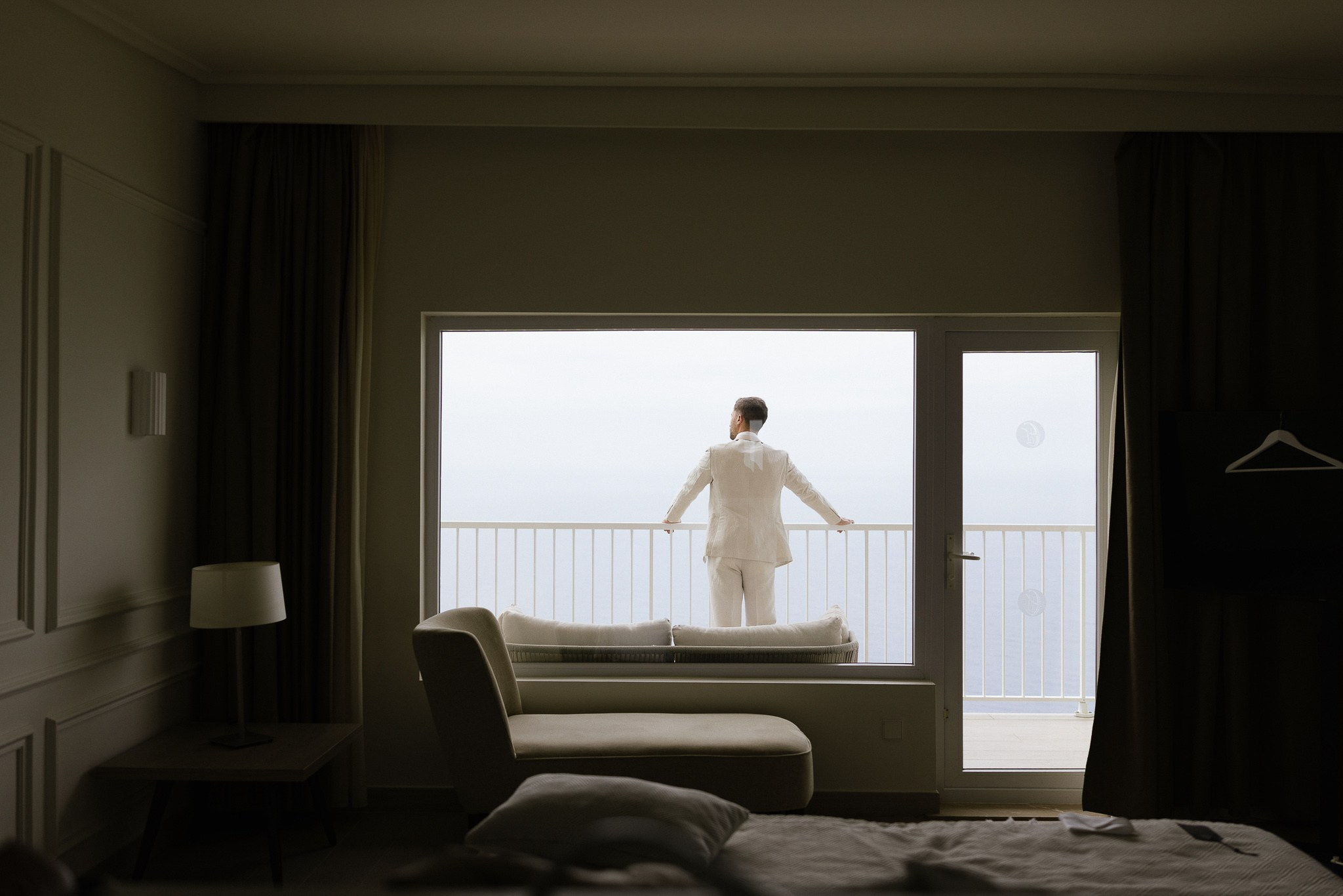 Groom looking out at the sea before Mallorca wedding