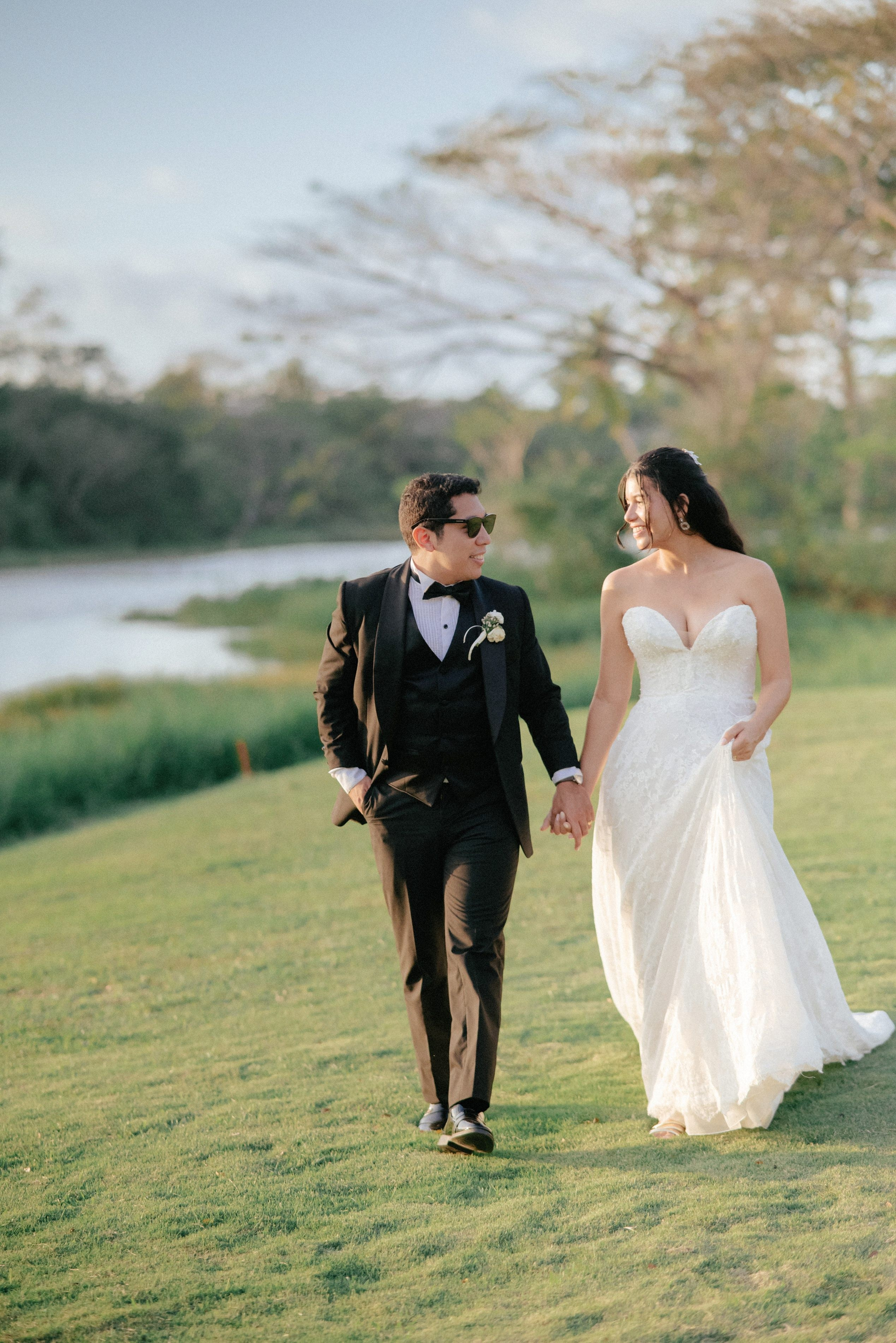 Bride and groom walking hand in hand in a garden in Cartagena, romantic wedding photography