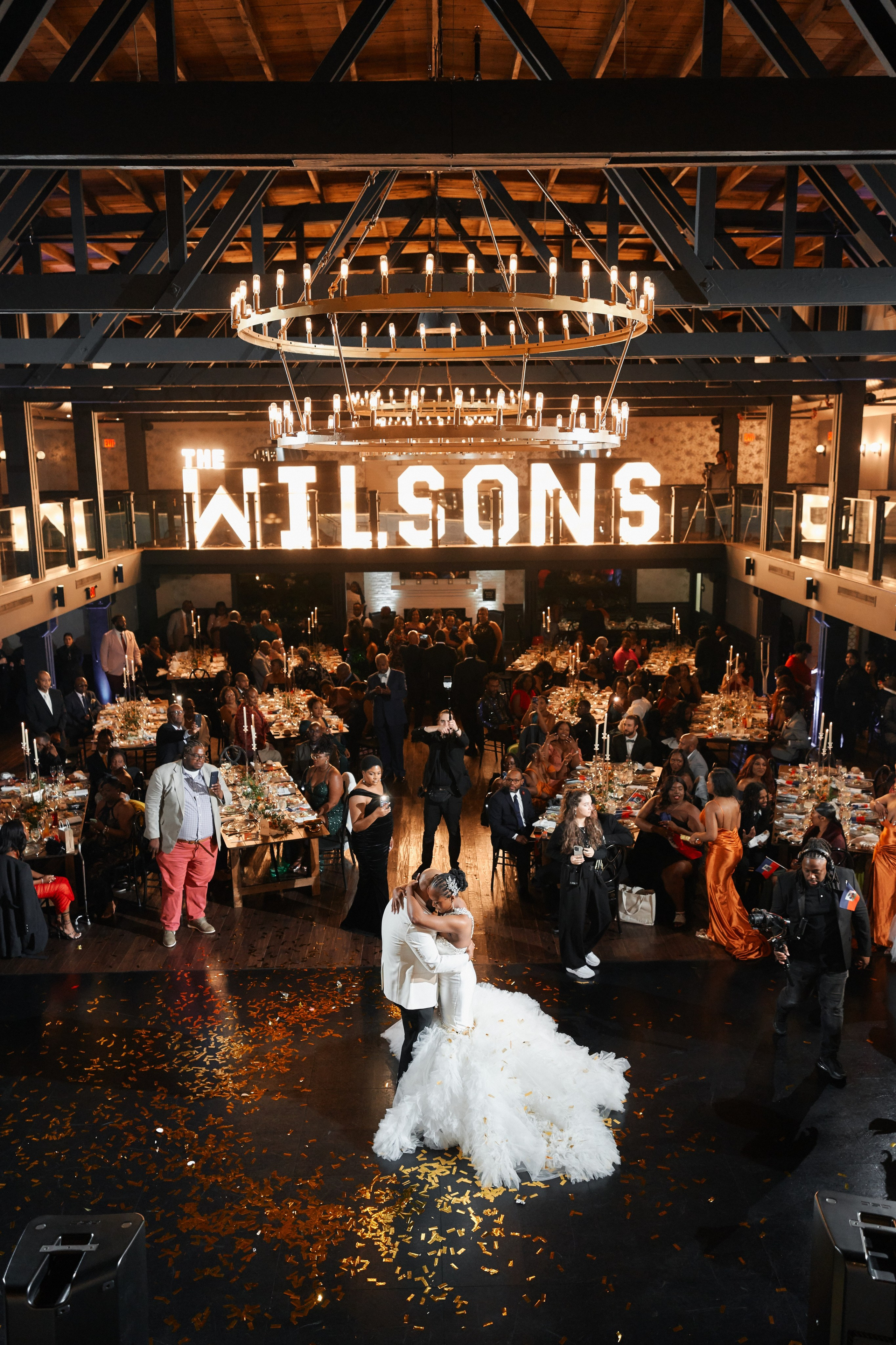 Luxury wedding reception with custom lighting decor and bride dancing in New York