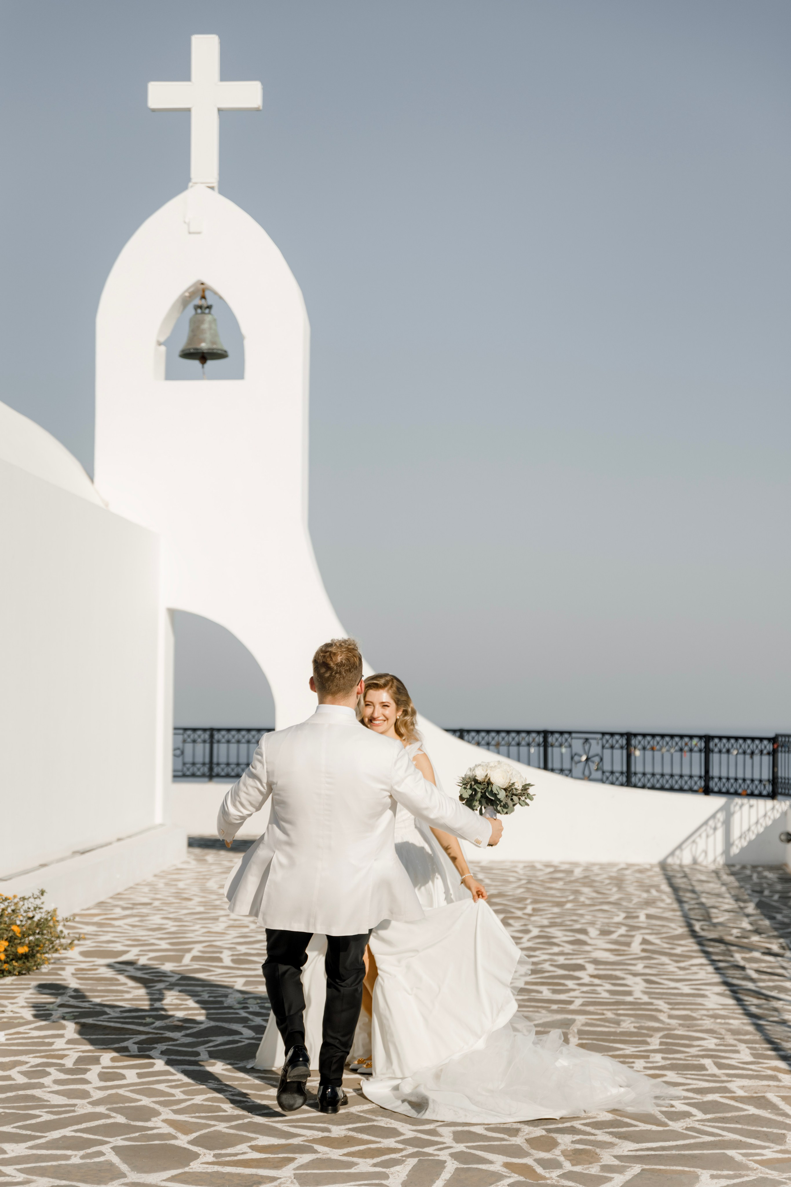 Groom are running to the bride. Church Agia Sofia in luxury hotel Esperos Village. Rhodes Greece