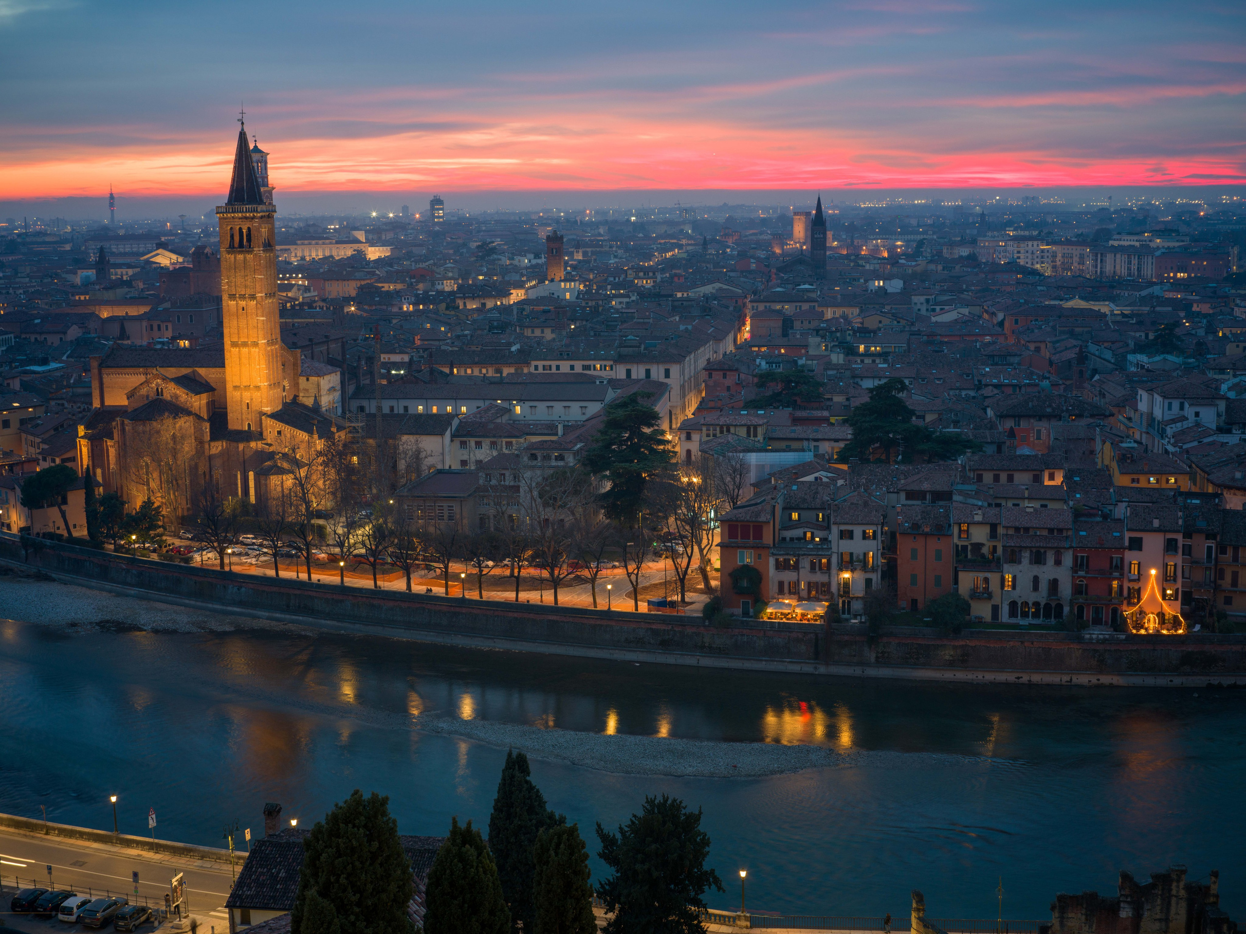 A cinematic sunset over Verona from Castel San Pietro. Warm red sky, glowing architecture and the Adige river create a timeless fine art cityscape for collectors and elegant interiors.