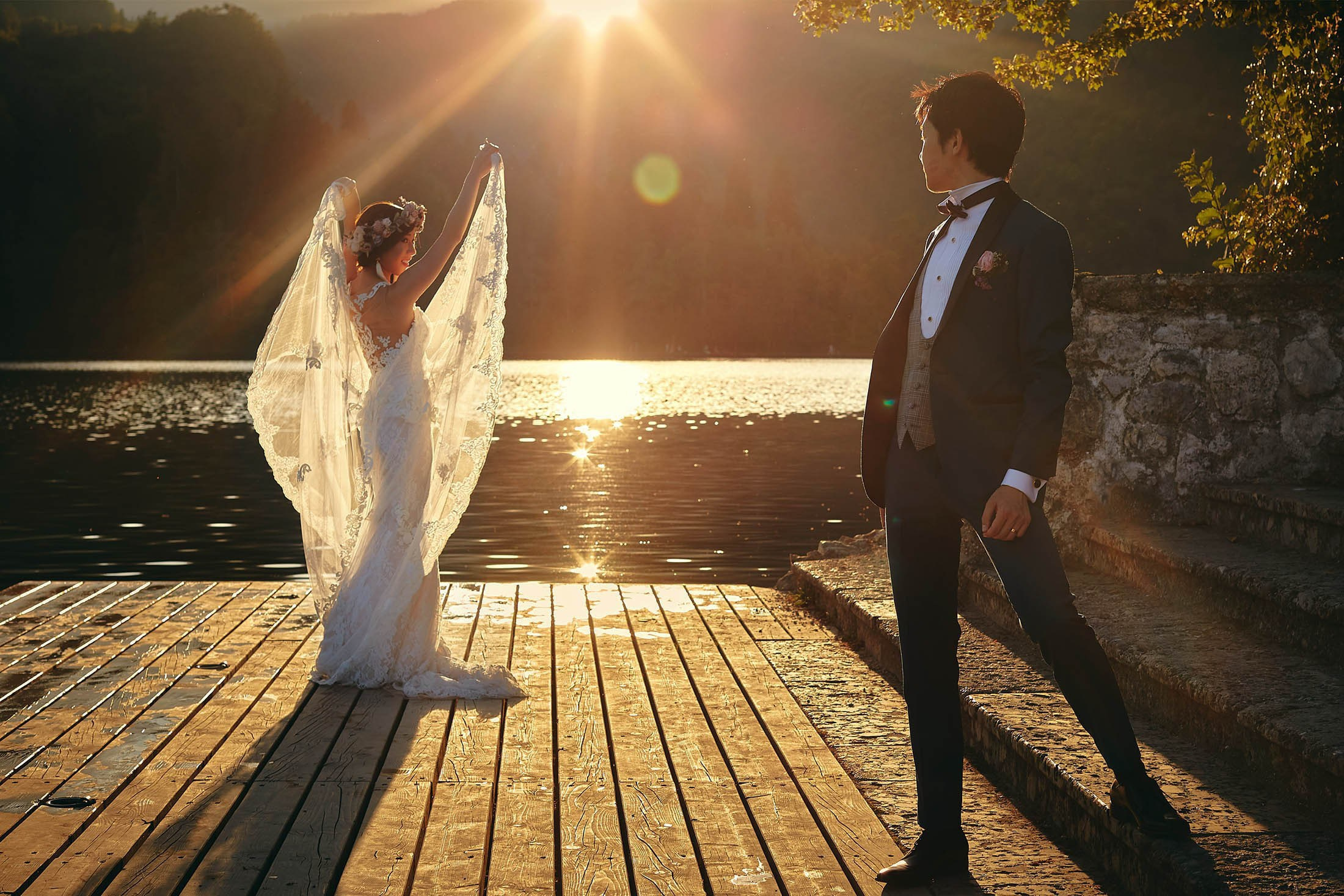 Backlit Japanese bride with veil on Lake Bled, Slovenia, wedding