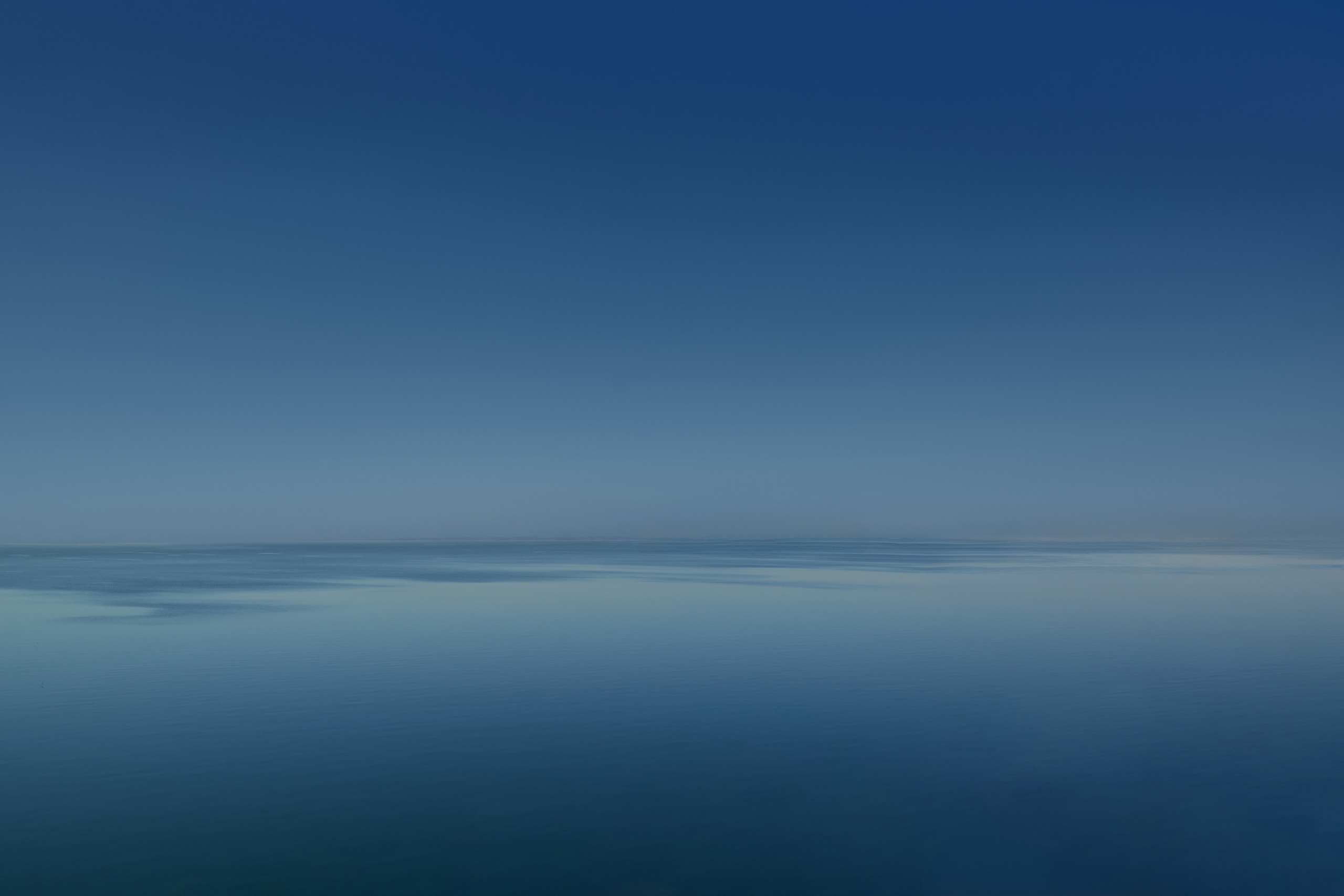 Minimalist horizon merging blue sea and sky