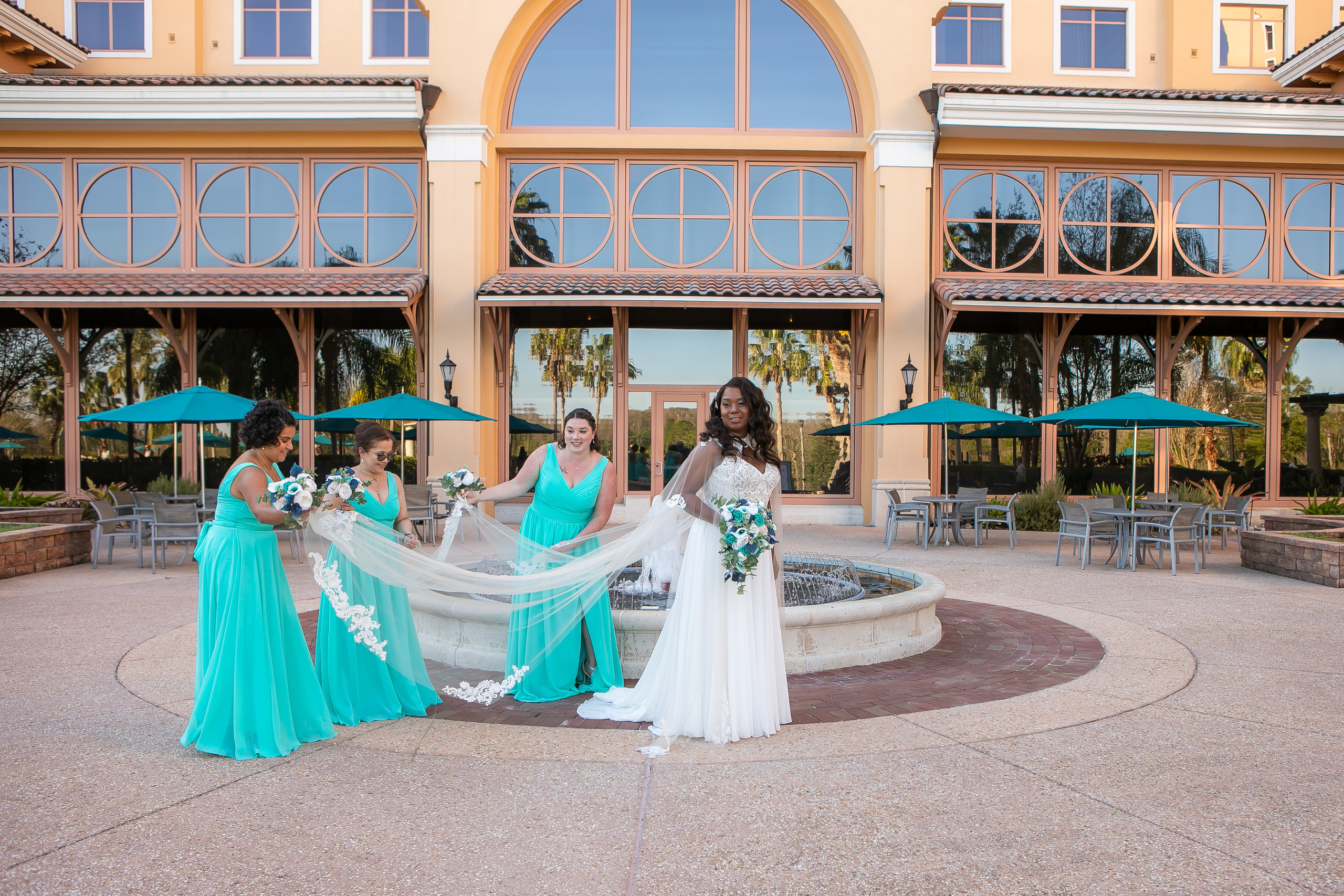 Bridesmaids holding a veil