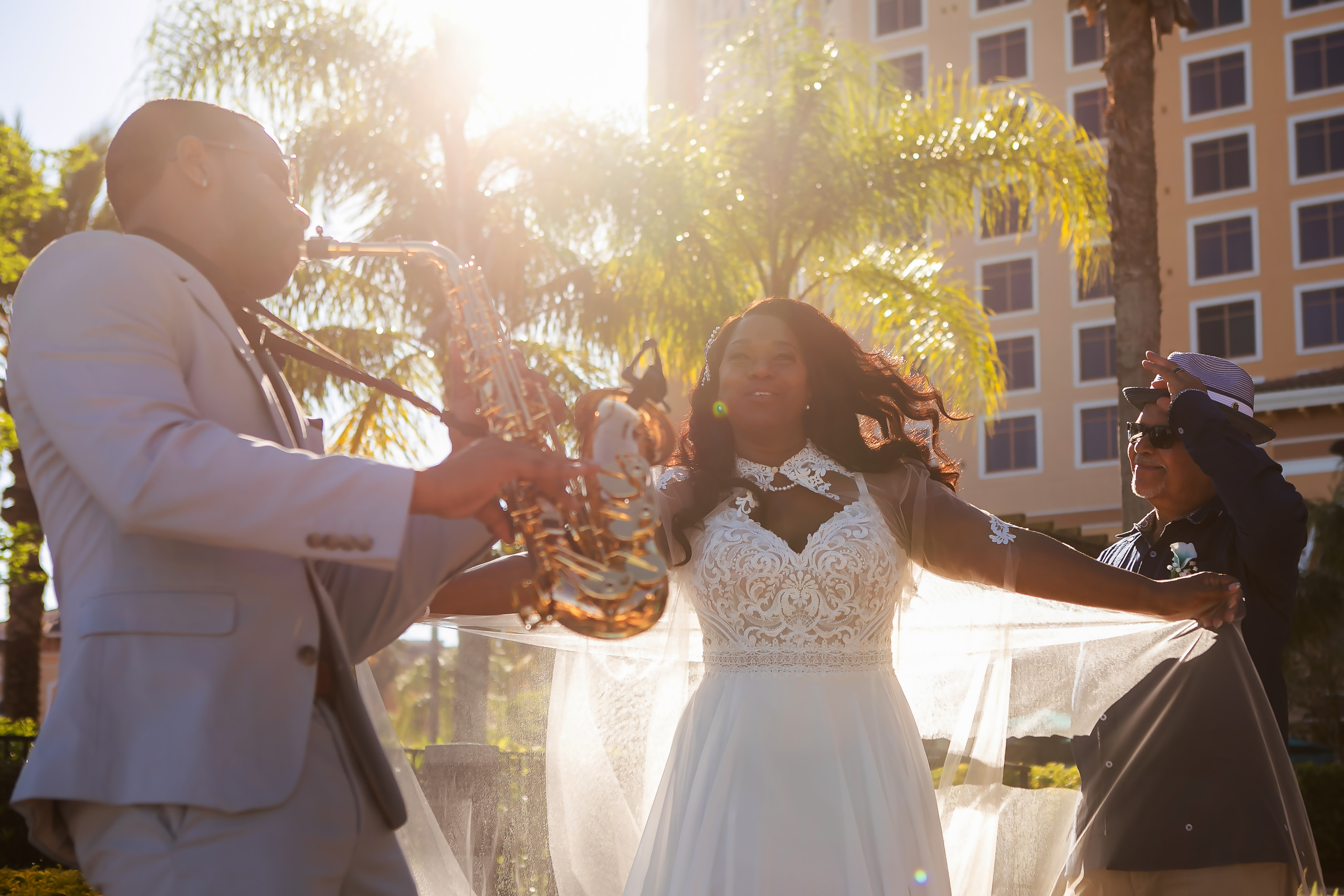 Bride & Groom and musician playing the saxophone