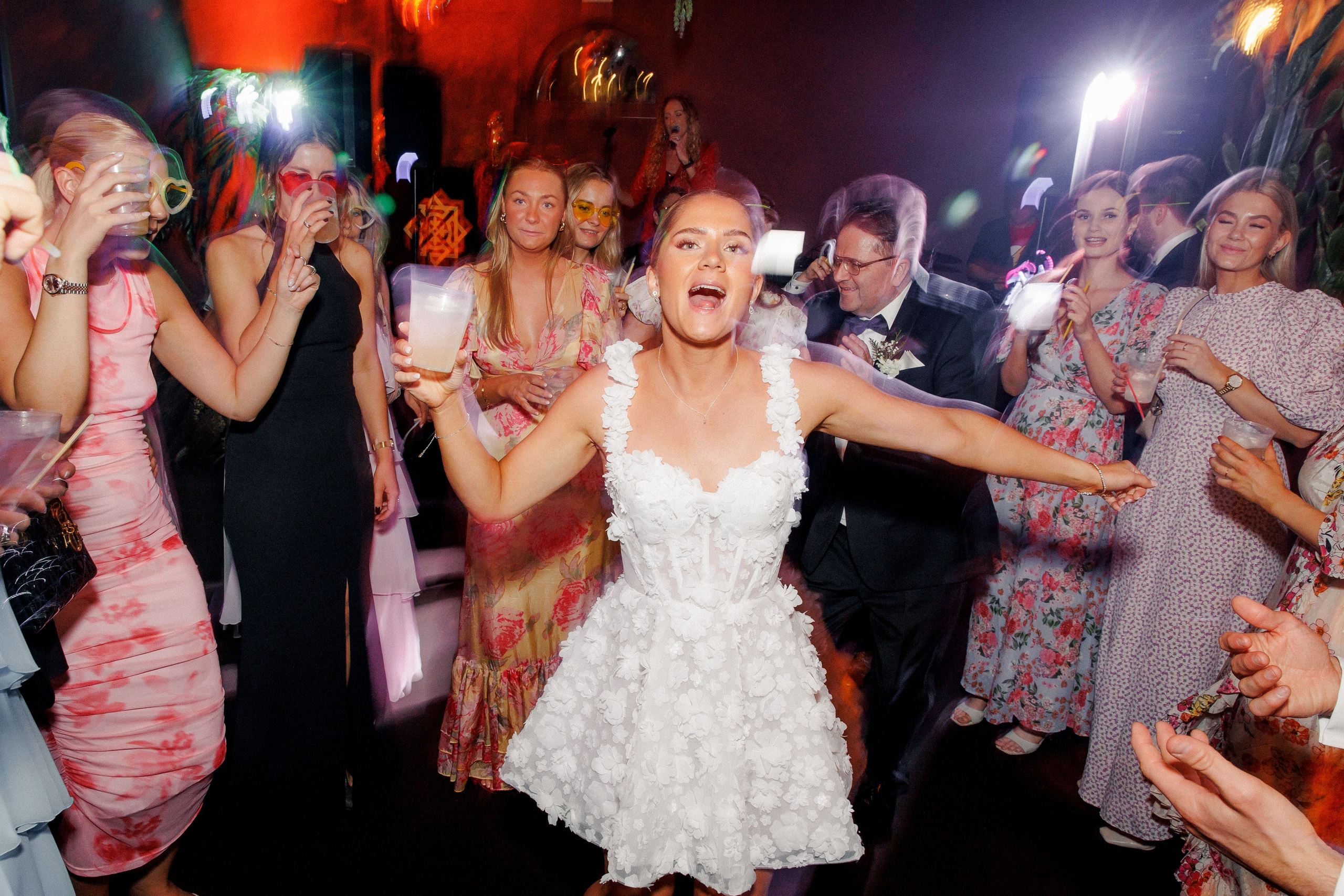Energetic wedding guests dancing on the dance floor during the reception in Barcelona, highlighting the celebration.