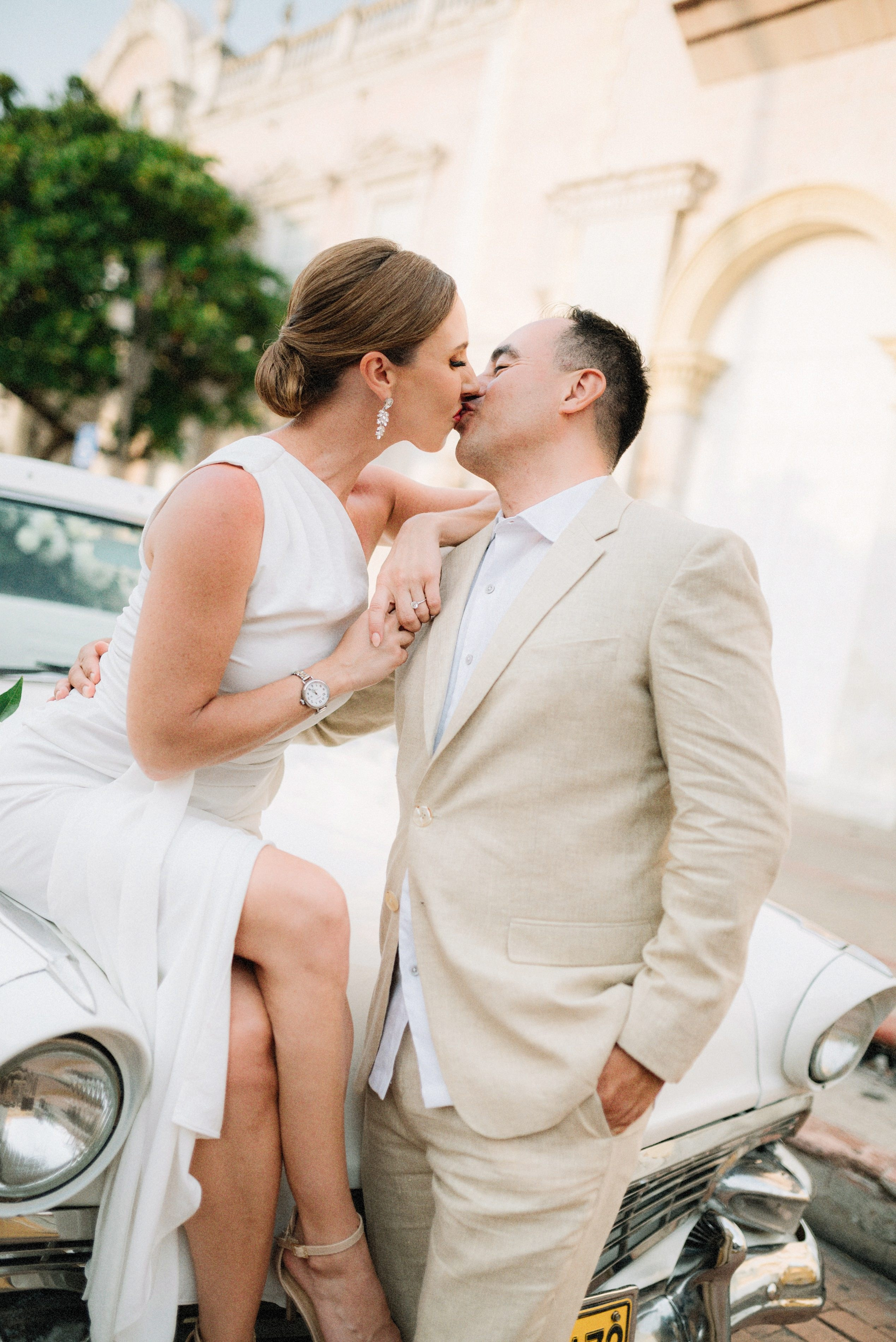 Couple kissing – “Bride and groom kissing outdoors, romantic wedding photography in Cartagena
