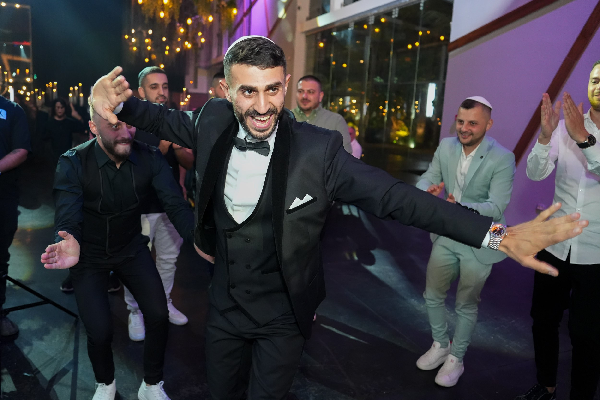 Groom Shimon dancing and laughing with his friends on the dance floor at 88 Event Garden in Emek Hefer, Israel