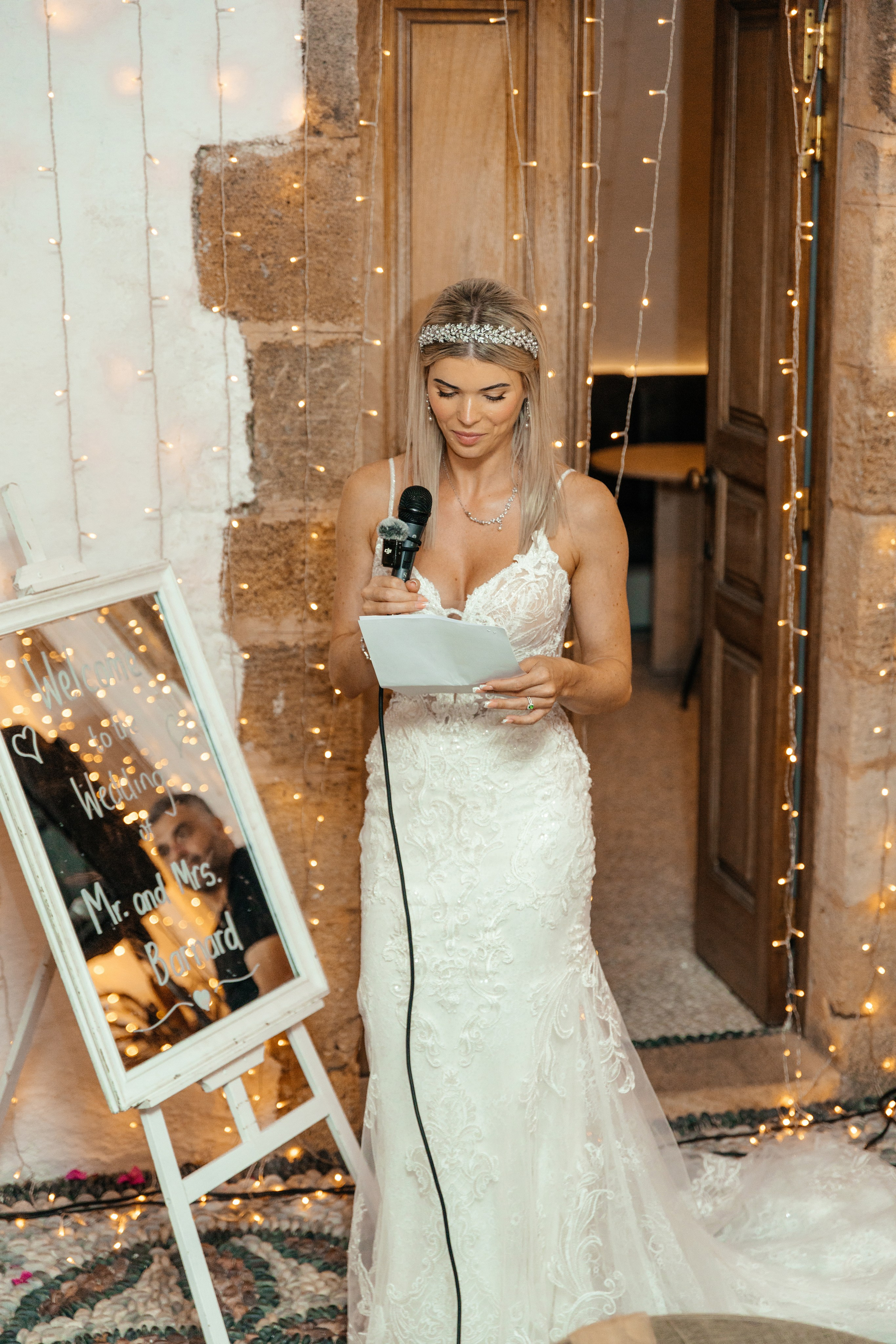 Bride is giving a touching speech at his wedding reception in a traditional Greek restaurant in Lindos, Greece, Rhodes.