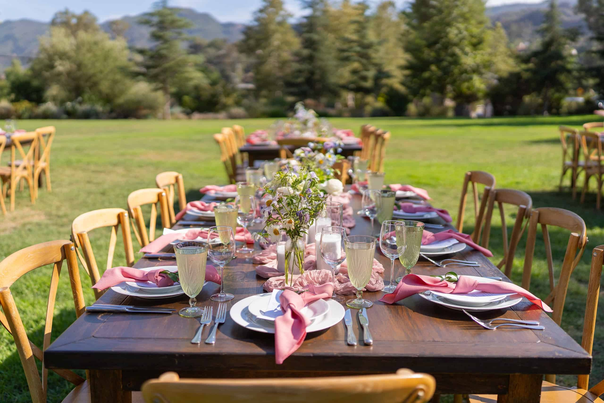Guest tables styled with modern blush florals and natural tableware