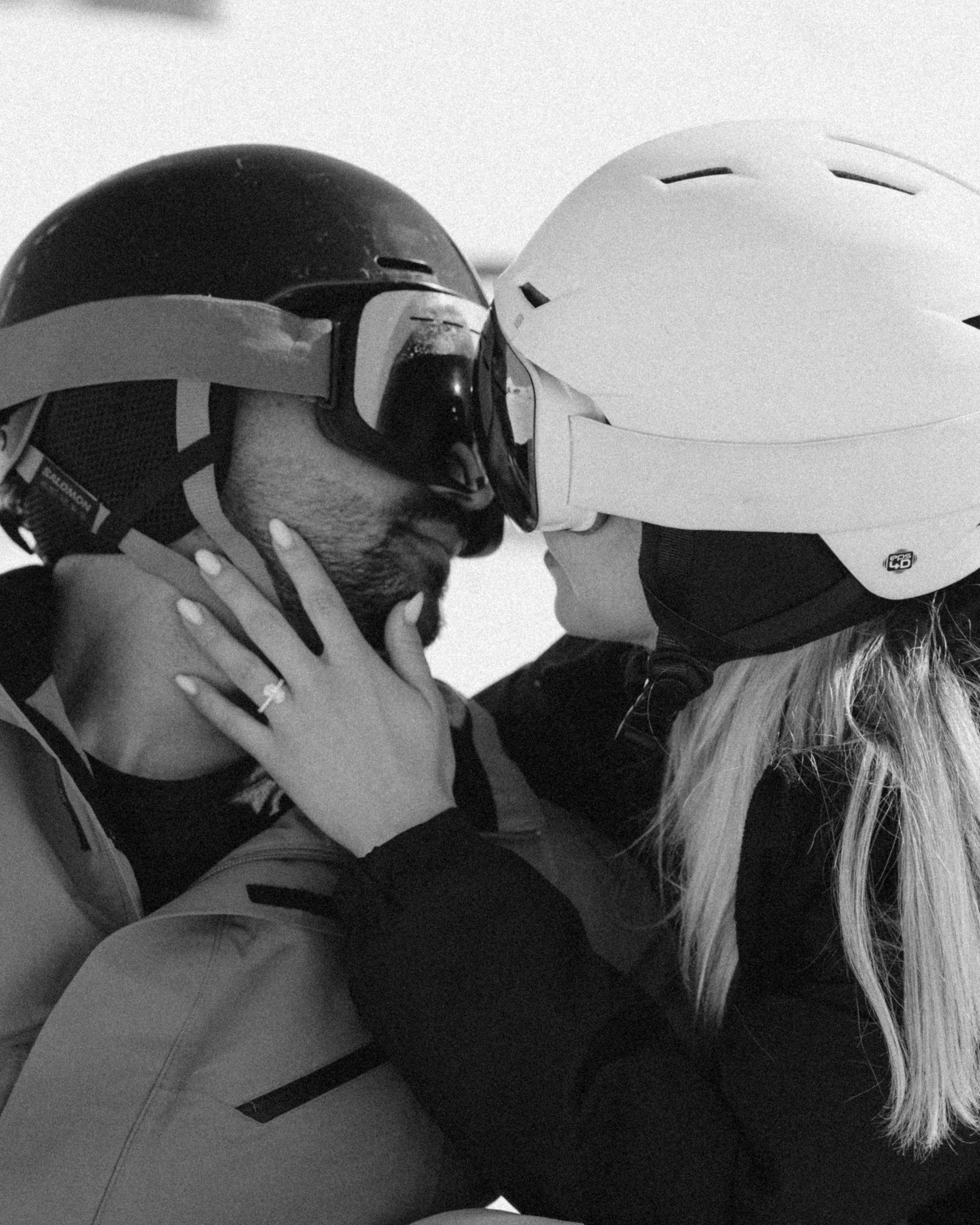 Couple kissing after surprise snowboard proposal at Gudauri ski resort