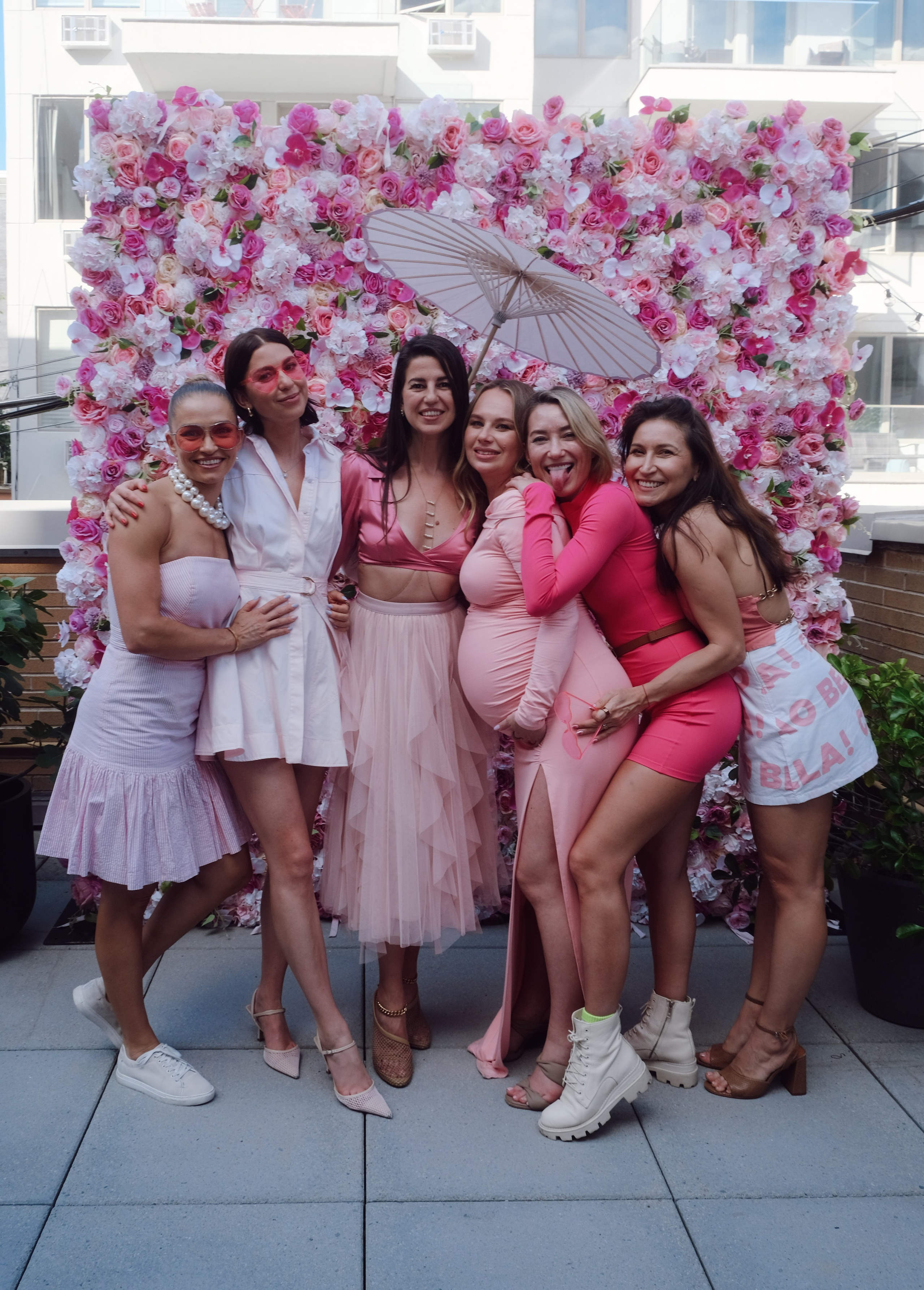 Mom-to-be surrounded by friends and flowers