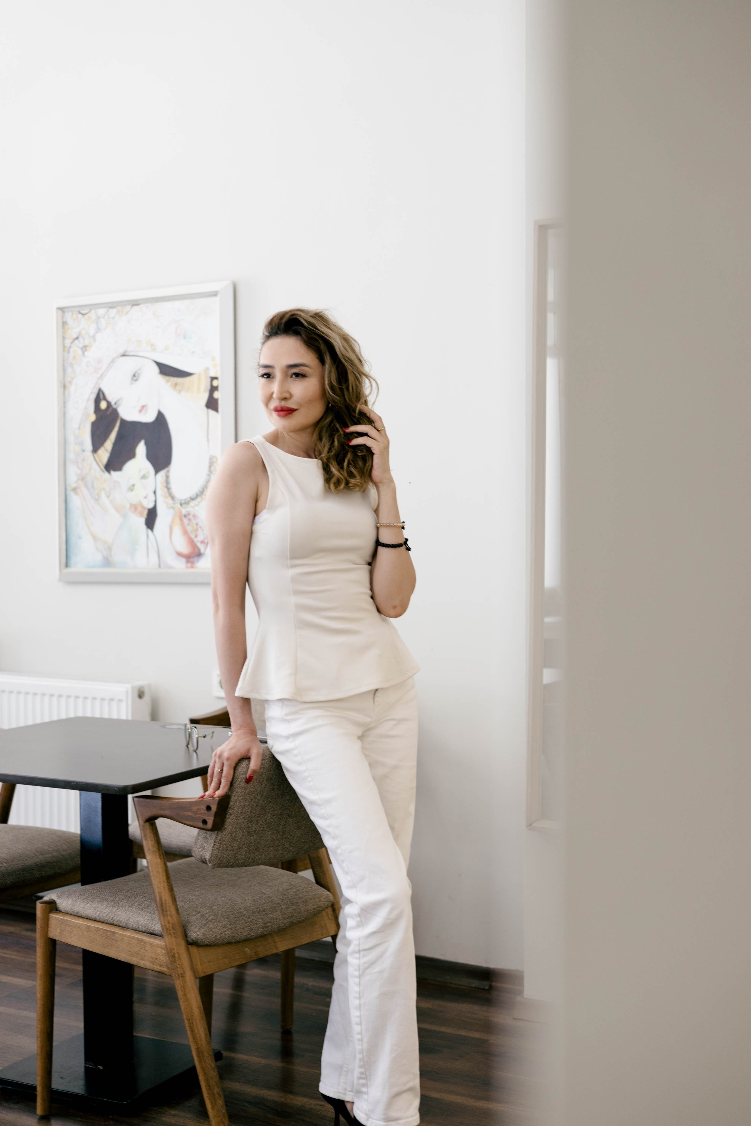 Woman standing near a chair during an indoor portrait session