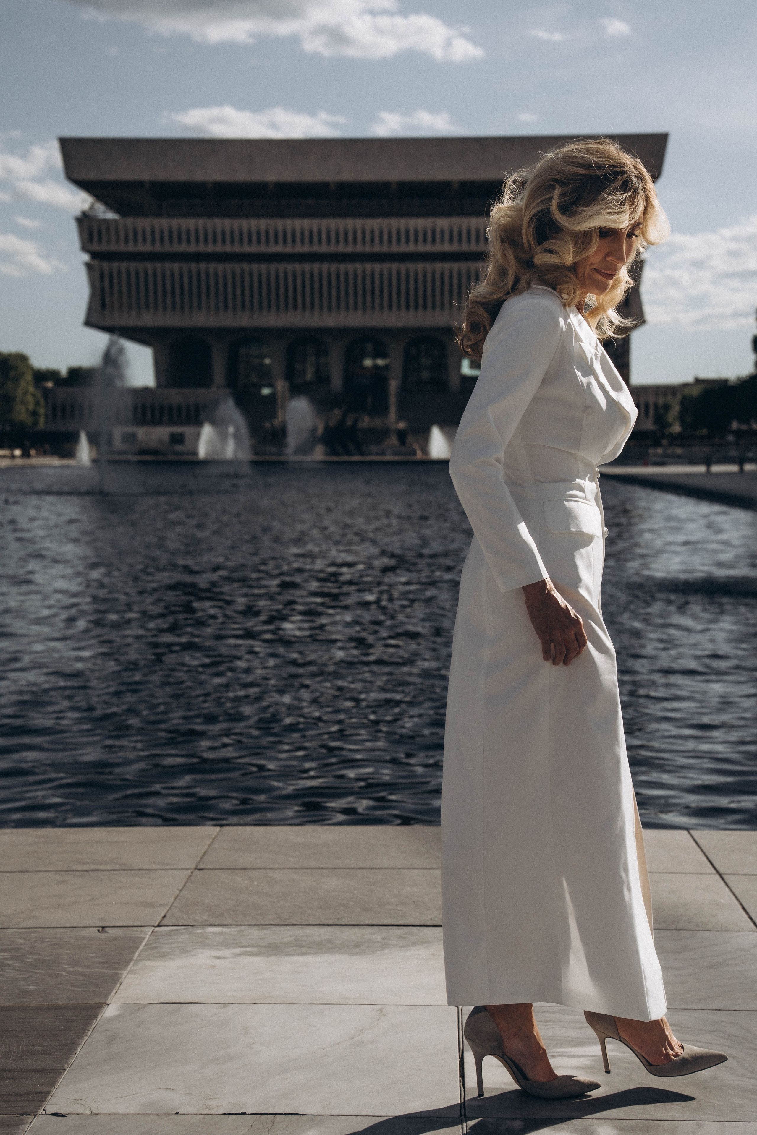 Smiling bride on Glens Falls bridge with flowers.